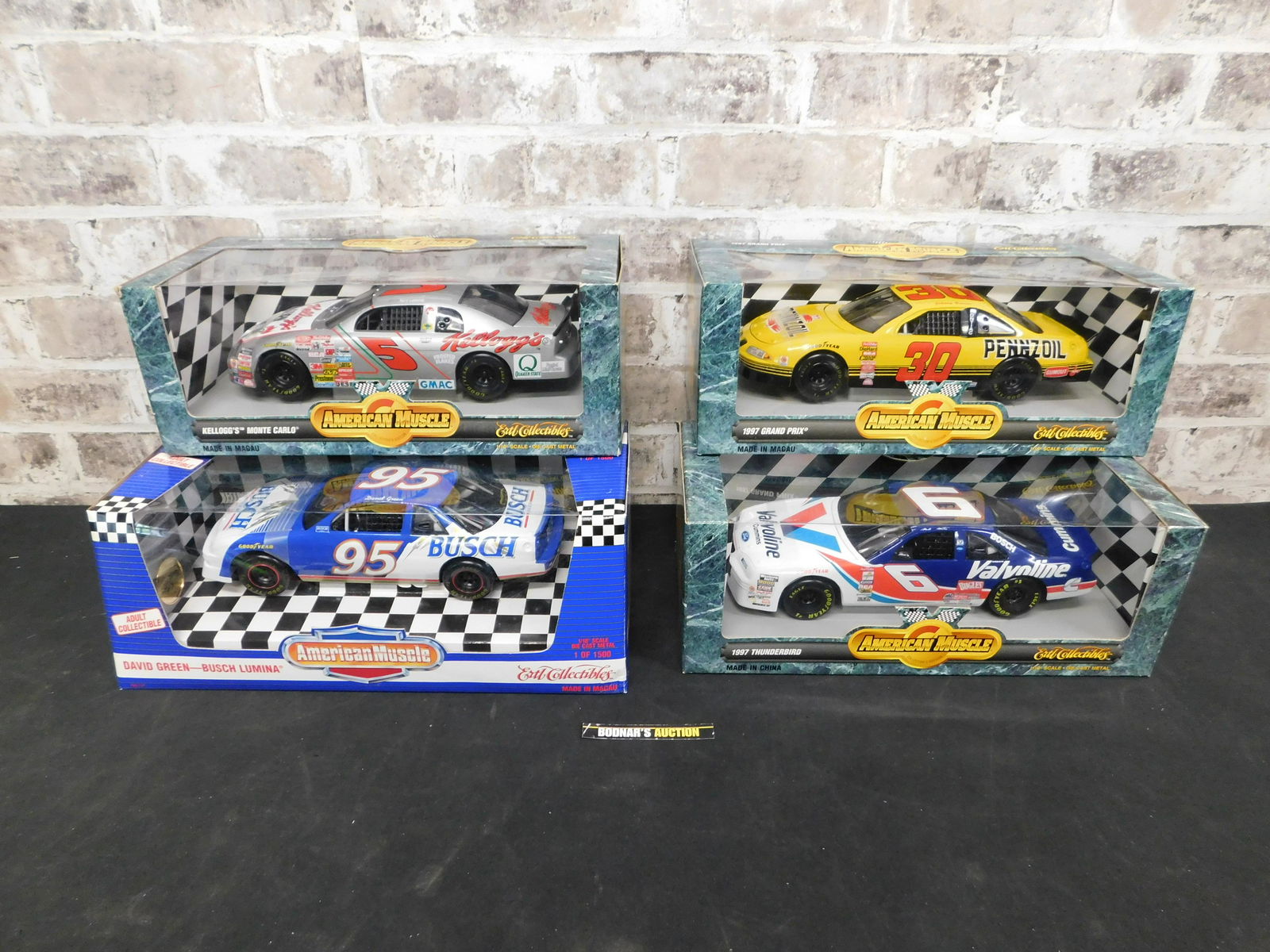 Lot of 4 American Muscle NASCAR Die-Cast: Lot of 4 American Muscle NASCAR 1:18 Scale Die-Cast Cars. Included in this lot is David Green - Busch Lumina Bank, 1997 Thunderbird - Mark Martin, Kellogg's Monte Carlo - Terry Labonte, and 1997 Grand