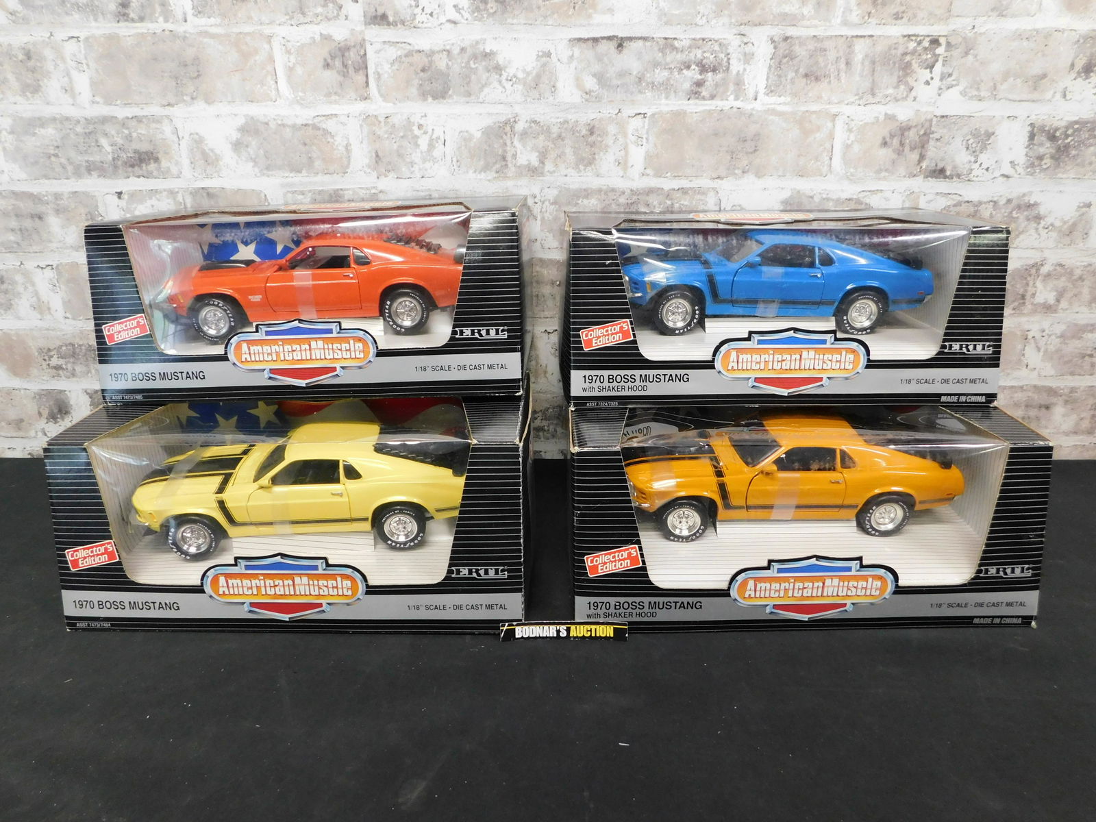 Lot of 4 American Muscle Boss Mustang 1:18 Scale: Lot of 4 American Muscle Mustang 1:18 Scale Die-Cast Cars. Included in this lot is a 1970 Boss Mustang - Yellow, 1970 Boss Mustang - Orange, 1970 Boss Mustang with Shaker Hood - Yellow, and 1970 Boss