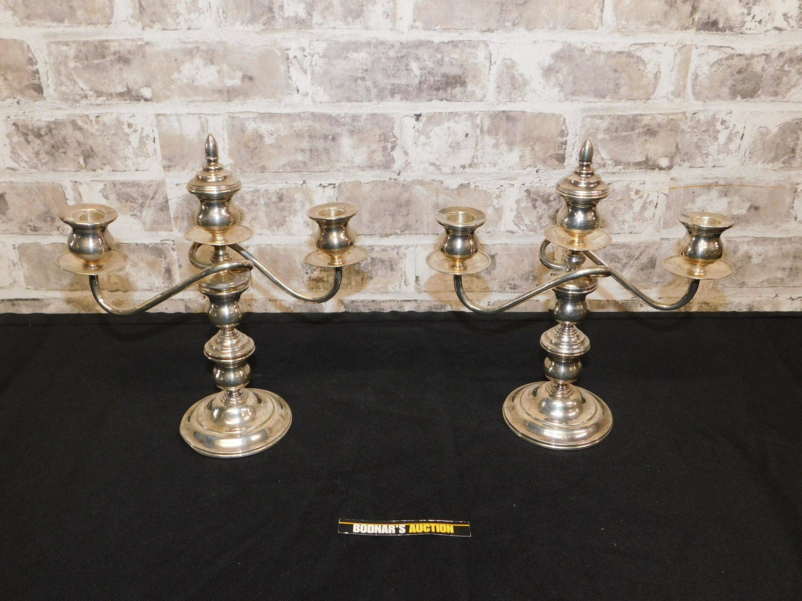 Pair of Sterling Silver Candelabras: Pair of Sterling Silver Candelabras. Bases have some denting that can be seen from underneath. They measure 9.5" tall x 9" wide. All invoices must be paid within 24 hours of the sale. All items are sh