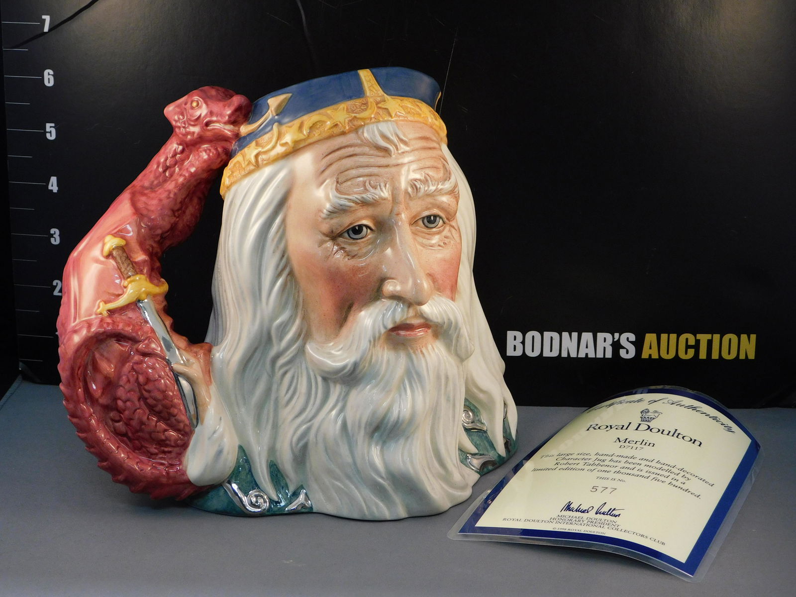 Royal Doulton Merlin Character Jug - D7117: Royal Doulton Merlin Character/Toby Jug. D7117. Dated 1998. Limited Edition 577/1500. Measures 7.5" tall x 8" wide. All invoices must be paid within 24 hours of the sale. All items are shipped USPS an