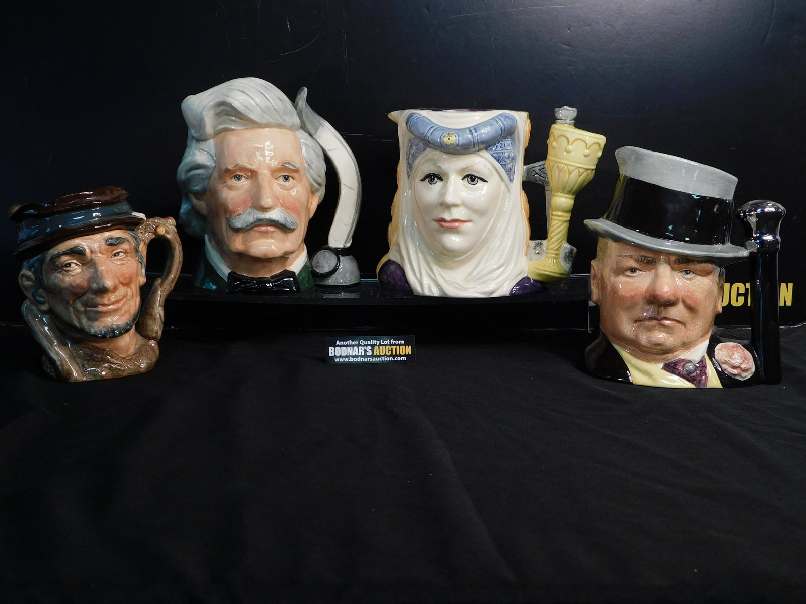 Lot of 4 Royal Doulton Character Jugs: Lot of 4 Royal Doulton Character/Toby Jugs. Included in this lot are Johnny Appleseed - D6372 dated 1952 measuring 6.5" tall x 6.5", Mark Twain - D6654 dated 1979 measuring 7.75" x 8", The Celebrity C