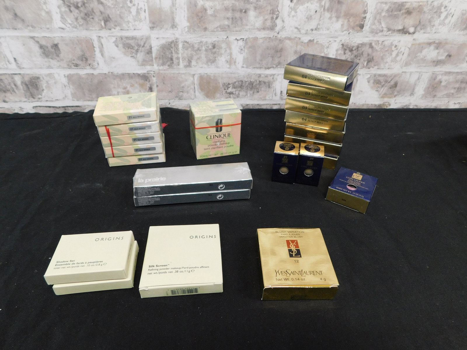 Mixed Lot of Cosmetics including Estee Lauder: Mixed Lot of Cosmetics including Estee Lauder, Clinique, Yves St. Laurent, and Origins. All New in Package. 24 Pieces. Includes Blush, Pressed Powder, Eye Shadow Sets, Eyebrow Pencil and More. You are