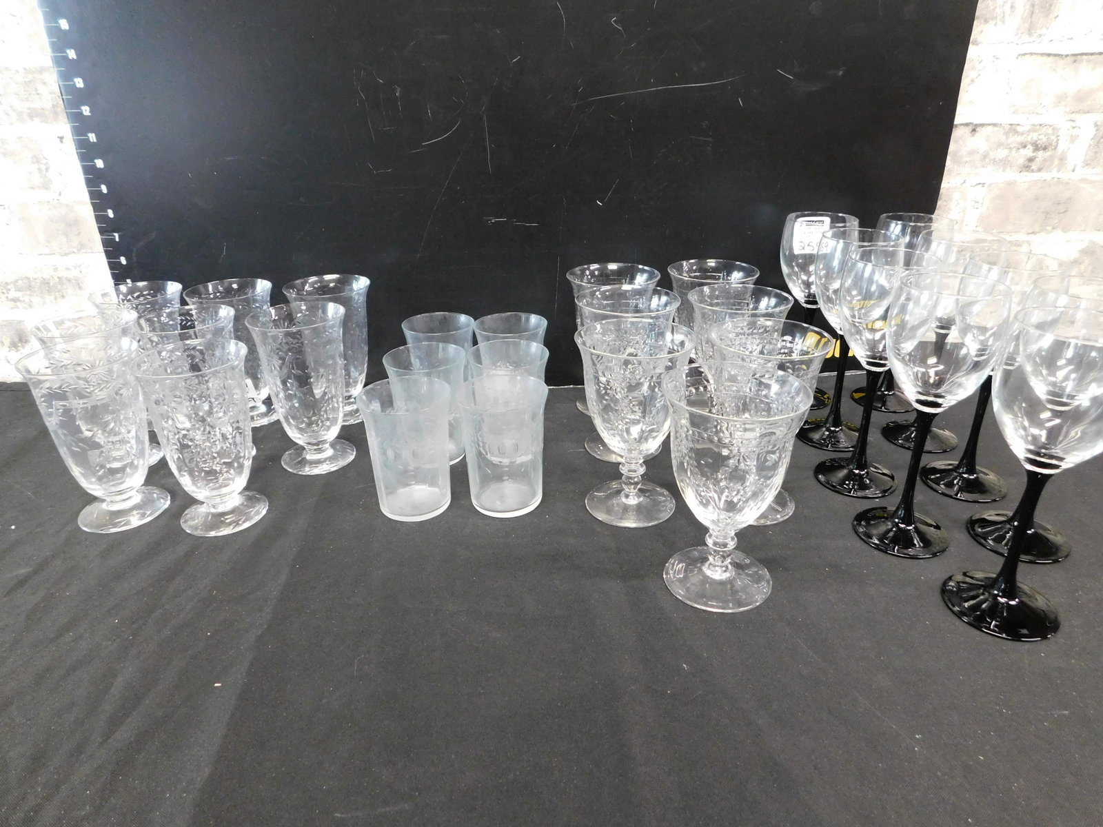 Lot of 21 Elegant Glass Stemware Set and 9 Amethyst: Lot of 21 Elegant Glass Stemware Set and a Set of 9 Amethyst Base Wine Glasses Signed France - Measuring 8" tall. The Elegant Glass Set includes (6) Orange Juices, (8) Juices and (7) Water Glasses. Po