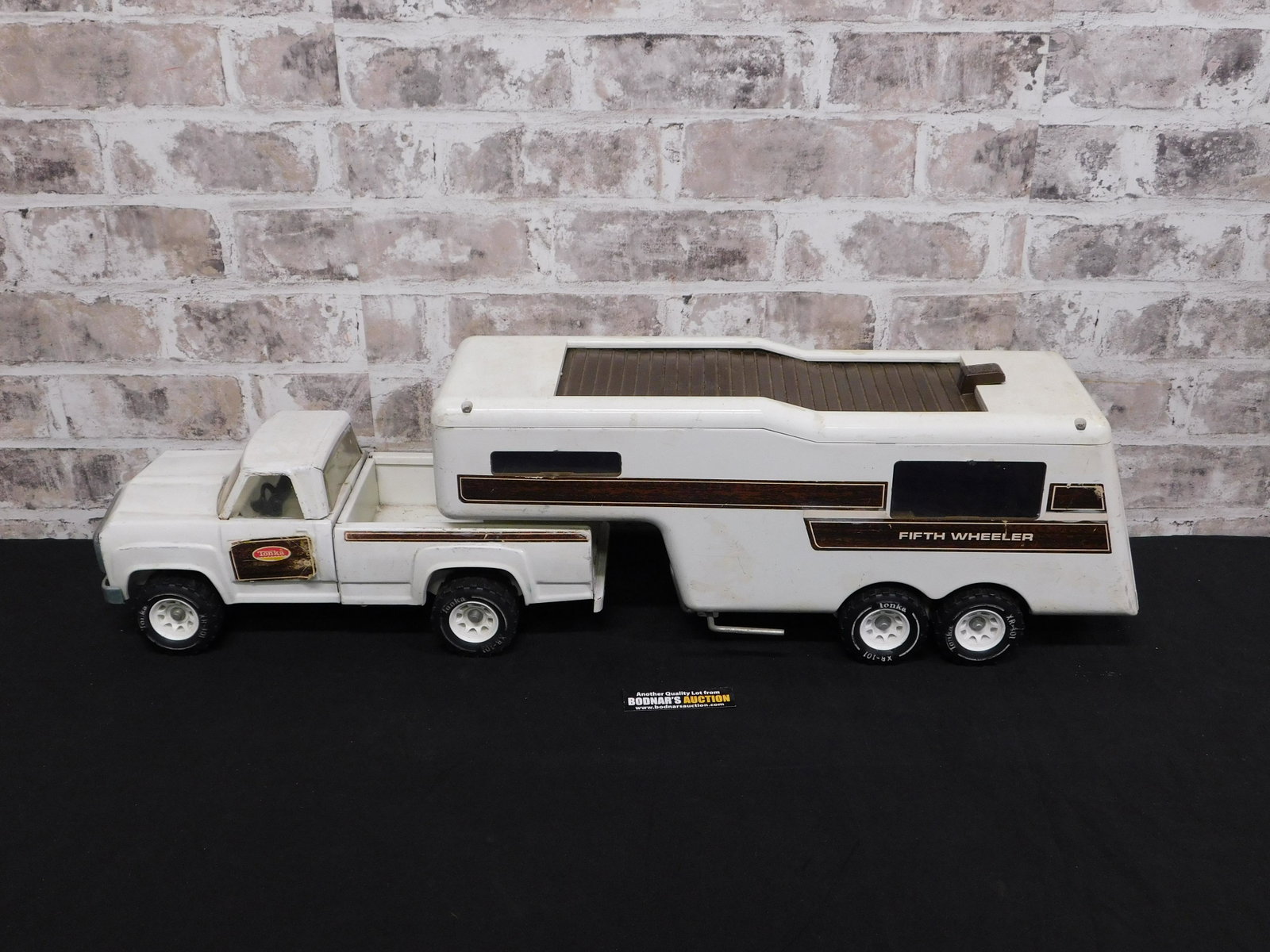Pressed Steel Vintage Tonka Truck: Pressed Steel Vintage Tonka Truck. Fifth Wheel Camper on Pick Up Truck. XR101. Used but Good Condition. Measures 29" long. Please read the terms and conditions. This sale will be broadcast live on sal