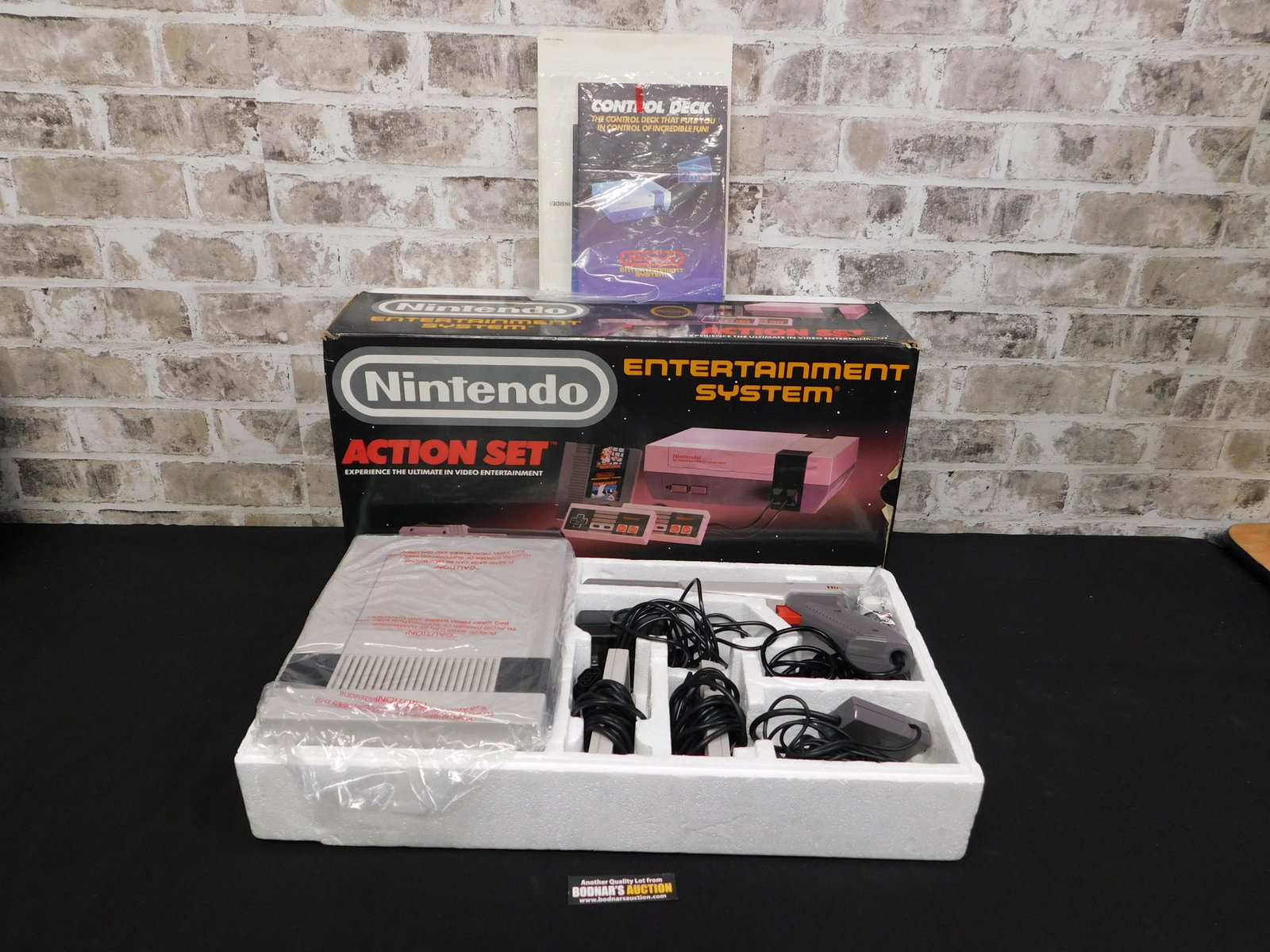 Nintendo Entertainment System in Original Box: Nintendo Entertainment System in Original Box and Original Plastic. Complete in Box with Duck Hunt Gun. Comes with Paperwork and Advertisements. Original Super Mario/Duck Hunt inside system. Please re
