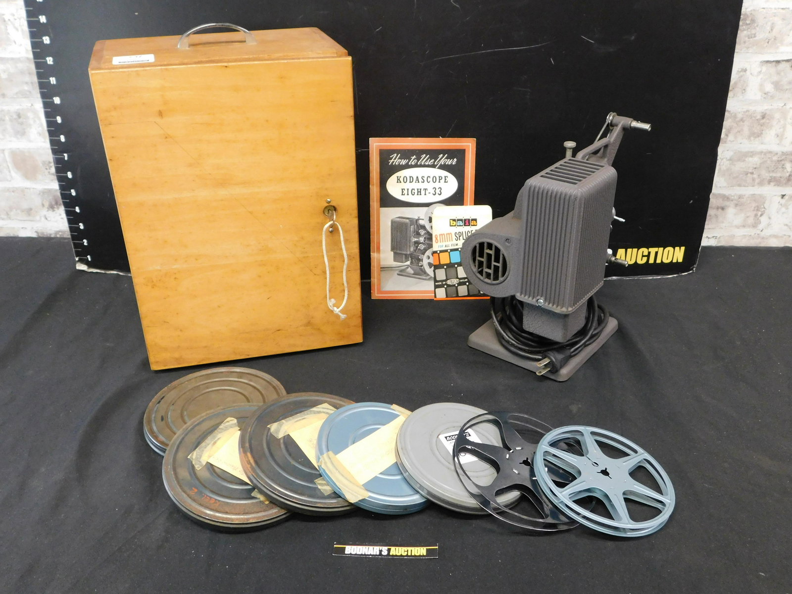 Kodascope Eight -33 Movie Projector: Kodascope Eight -33 Movie Projector in original wood box with several rolls of film. Please read the terms and conditions. This sale will be broadcast live on sale day with full descriptions of each l