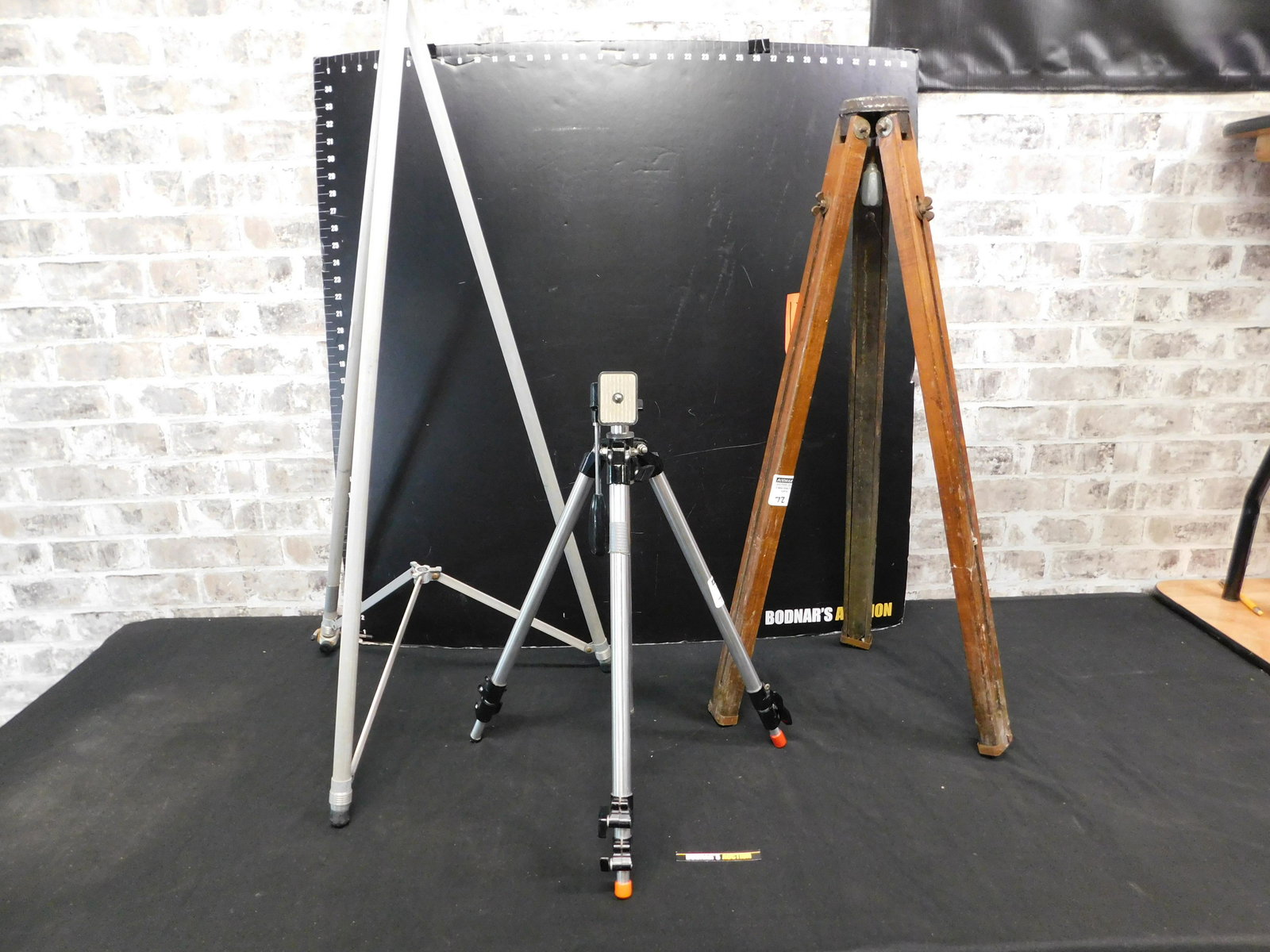 Lot of 3 Camera Tripods: Lot of 3 Camera Tripods including 1 Vintage Wooden Tripod. Please read the terms and conditions. This sale will be broadcast live on sale day with full descriptions of each lot being sold, as well as