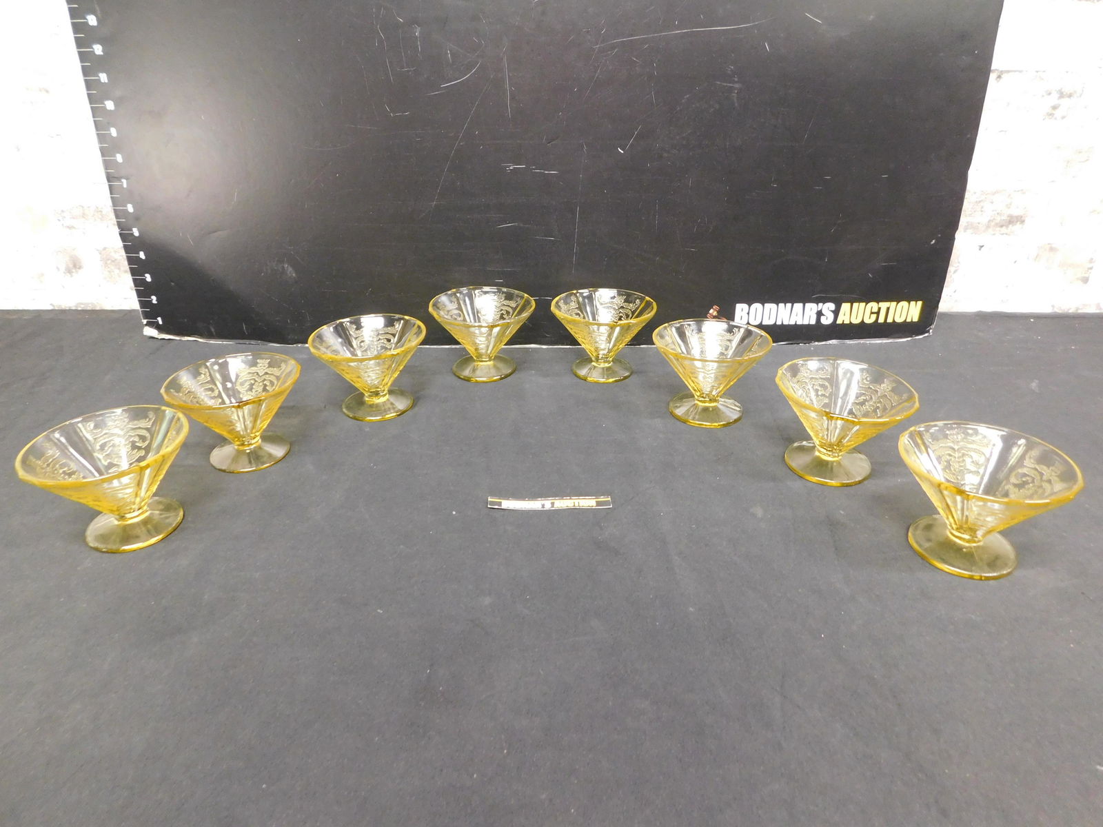 Lot of 8 Madrid Amber Depression Glass Footed Sherbets: Lot of 8 Madrid Amber Depression Glass Footed Sherbets. Measures 3" tall x 4" diameter. Please read the terms and conditions. This sale will be broadcast live on sale day with full descriptions of eac