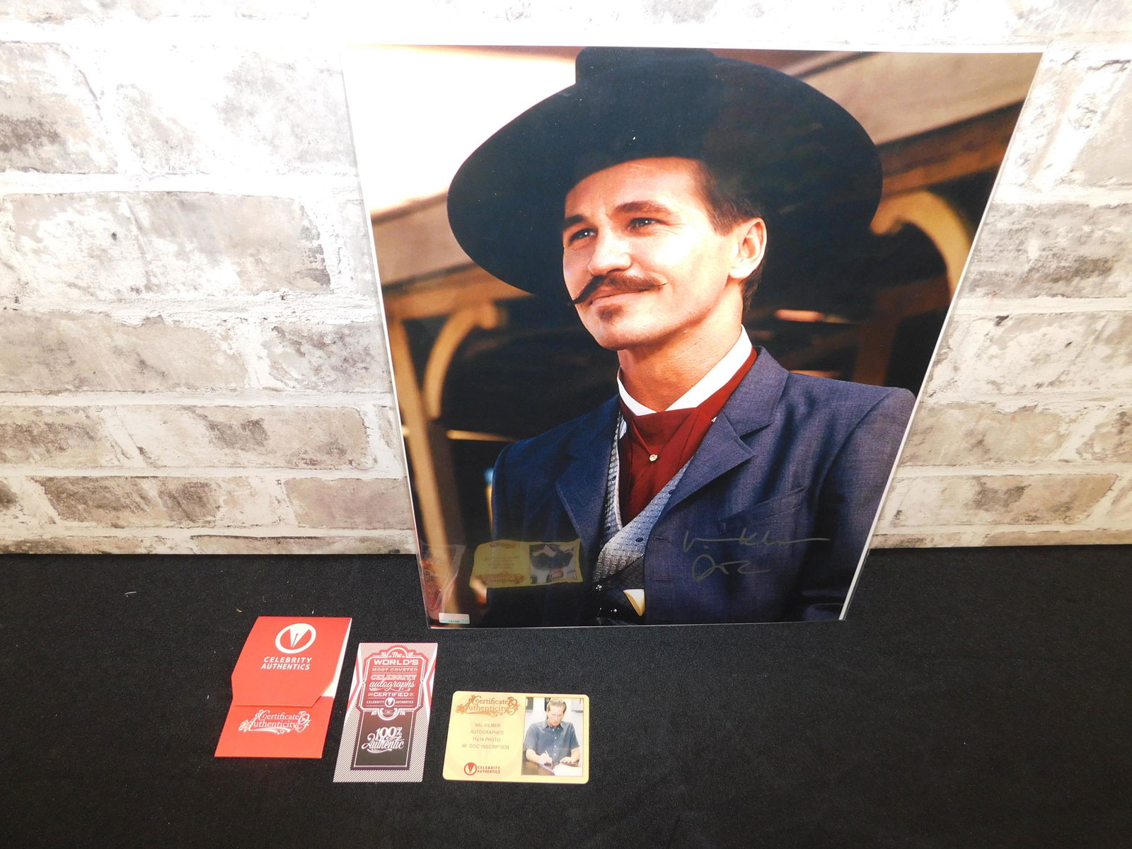 Val Kilmer Autographed Doc Holiday Photo: Autographed photo of Val Kilmer as Doc Holiday. Autographed by Val Kilmer, Has Celebrity Authentics COA and Measures approx. 14" t x 11" w. All invoices must be paid within 24 hours of the sale. All i