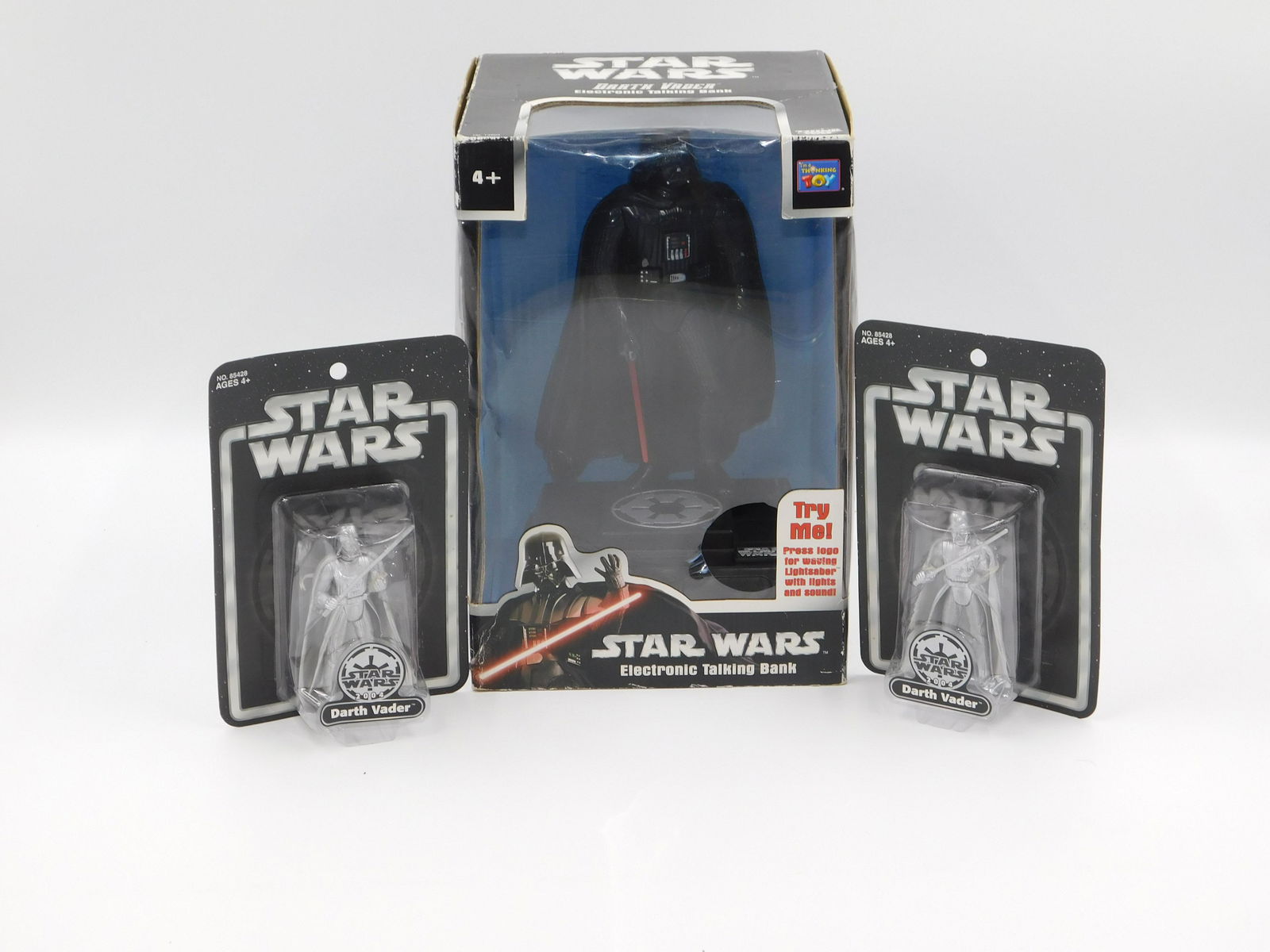 Star Wars Darth Vader Group: 3 Darth Vader items including a Star Wars electronic talking bank in original box and 2 25th anniversary silver Darth Vader figures on original card. All invoices must be paid within 24 hours of the s