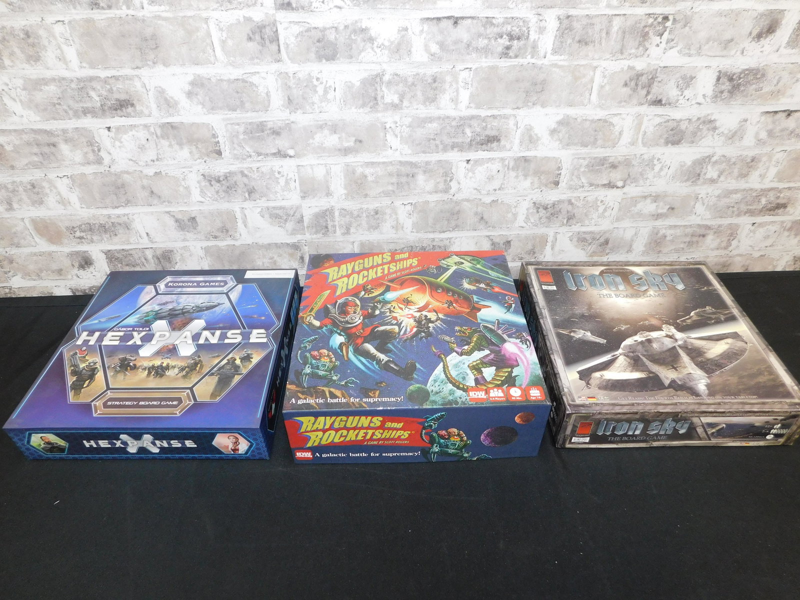 Lot of 3 Strategy/Board Games: Lot of 3 Strategy/Board Games including Hexpanse by Korona Games - Parts Unpunched - Seems to be in Excellent Condition, Iron Sky by ReVision - New Condition in Opened Box, and Rayguns and Rocketships