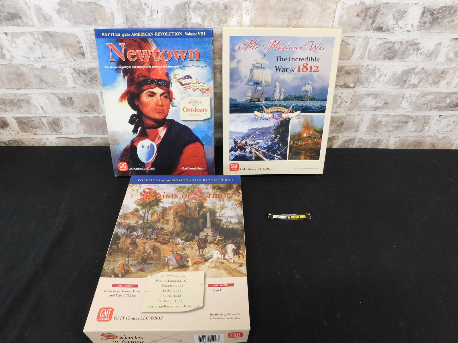 Lot of 3 War Strategy Games: Lot of 3 War Strategy Games by GMT including Saints in Armor - Used/Very Good Condition, Mister Madison's War - Unpunched/Excellent, and Newtown - Unpunched/Excellent. Please refer to the photos for g