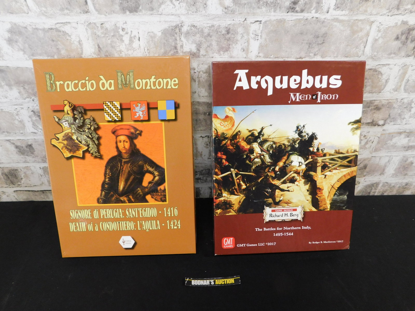 Lot of 2 War Strategy Games: Lot of 2 War Strategy Games including Arquebus Men of Iron by GMT - Used/Very Good Condition and Braccio da Montone by Acies - Unpunched/Excellent. Please refer to the photos for game contents Please 