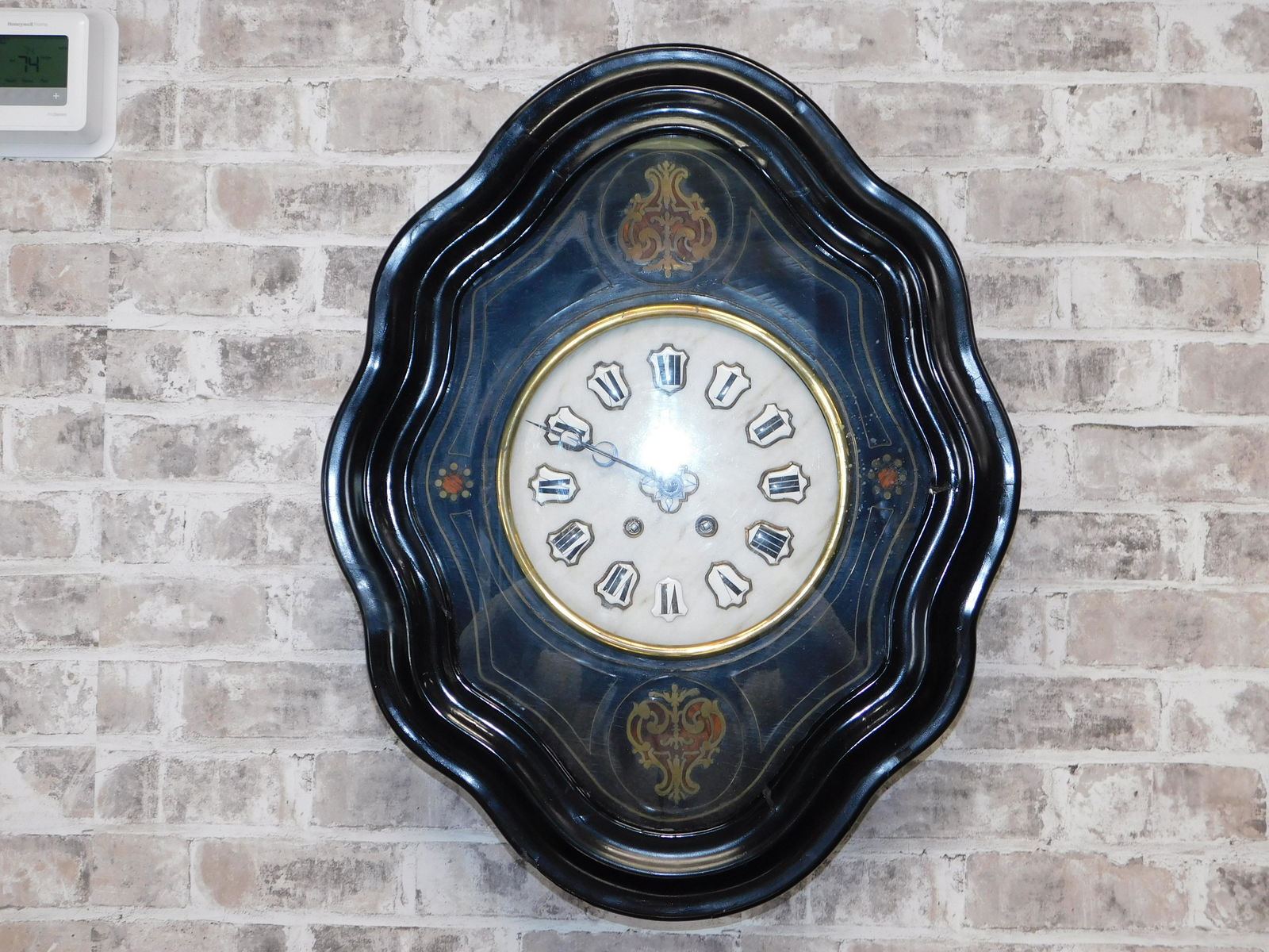 French Style Regulator Clock: Victorian French Style Wall Regulator Clock. It has brass and wood inlay, and marble face. Includes the pendulum. It is missing some pencil inlays around the face. Measures approx. 24.5x20 inches. Ple