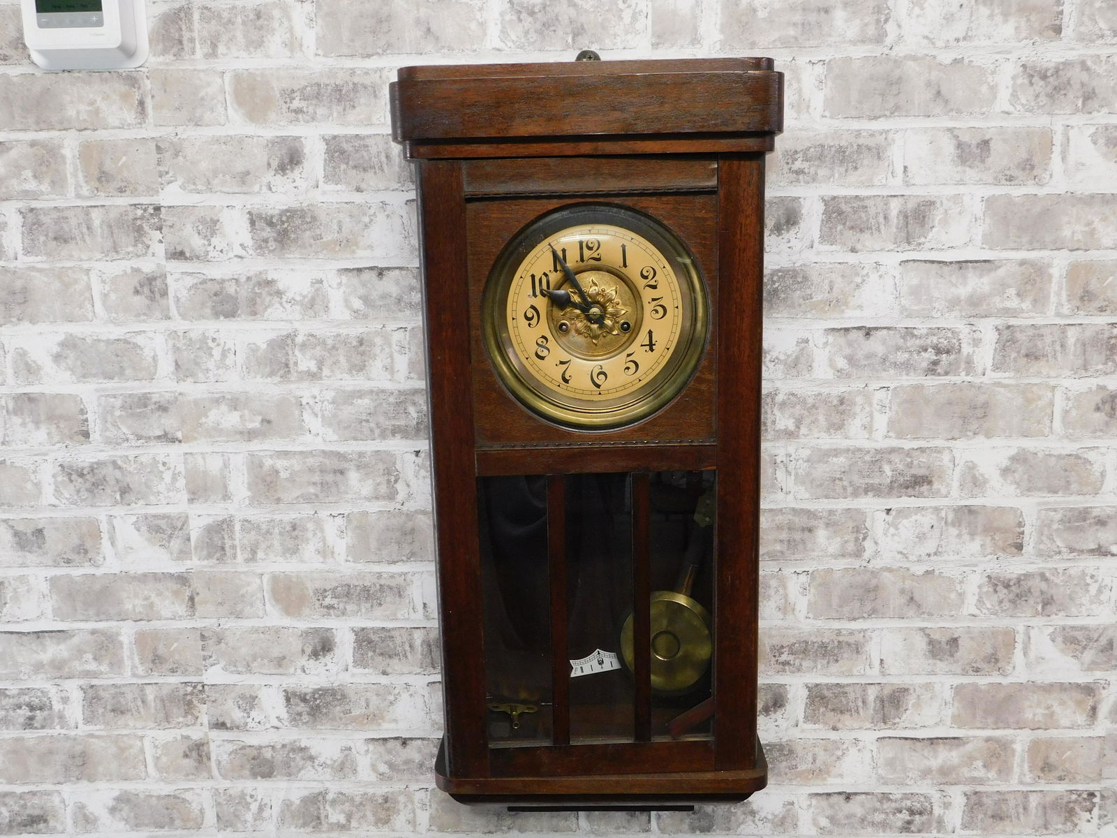 Wall Regulator Clock: Wall regulator clock with pendulum. Has some veneer issues. Measures approx. 29.5 inches tall by 13.5 inches wide. Please read the terms and conditions. This sale will be broadcast live on sale day wi