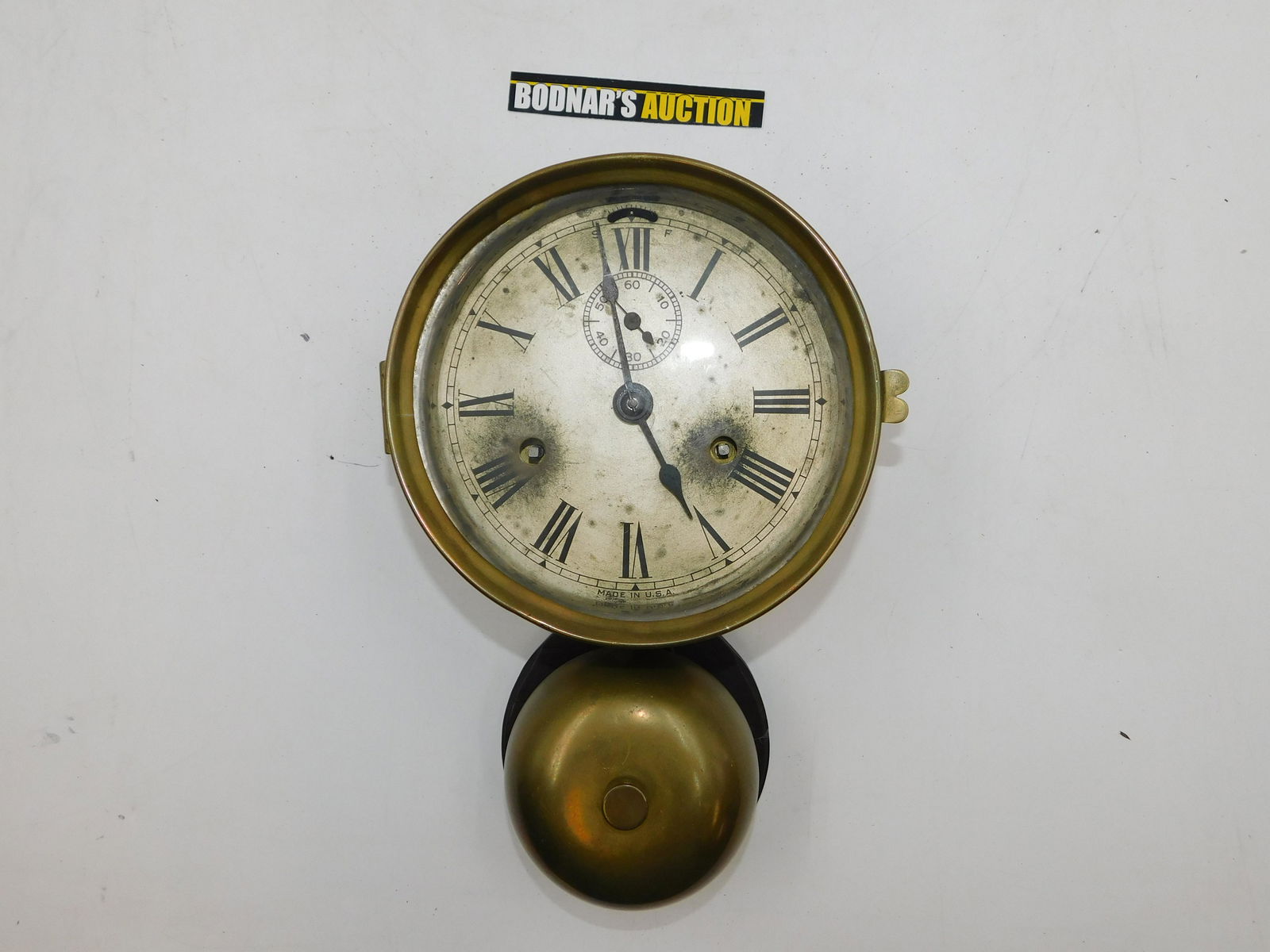 Ships Bell Clock: Ships bell clock. Measures approx. 10.5 inches tall by 7 inches wide. Please read the terms and conditions. This sale will be broadcast live on sale day with full descriptions of each lot being sold.
