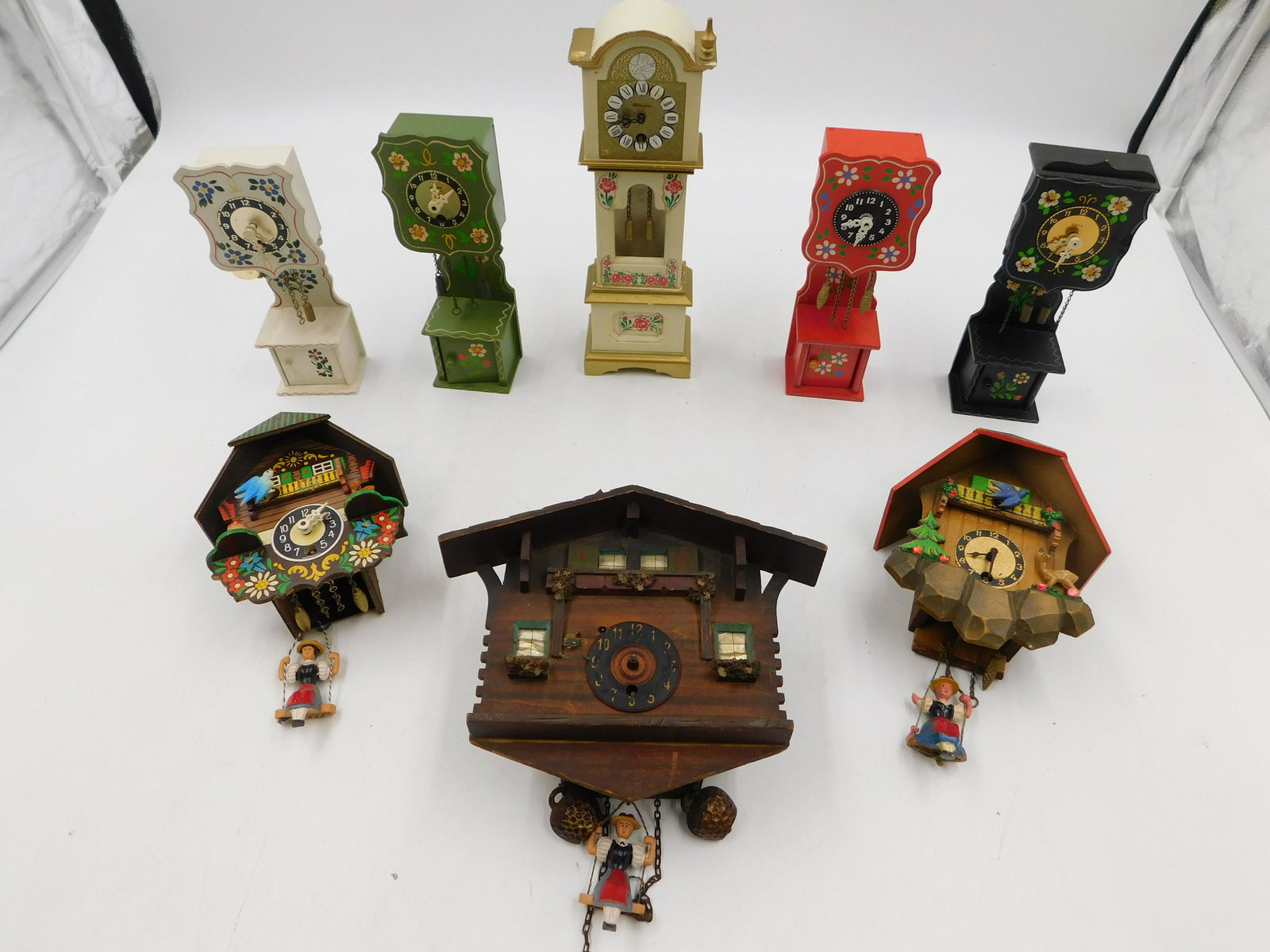 Group Lot of Wood Cuckoo and Novelty Grandfather Clocks: Group Lot of Wood Cuckoo and Novelty Grandfather Clocks. Mostly As-Found. Please read the terms and conditions. This sale will be broadcast live on sale day with full descriptions of each lot being so
