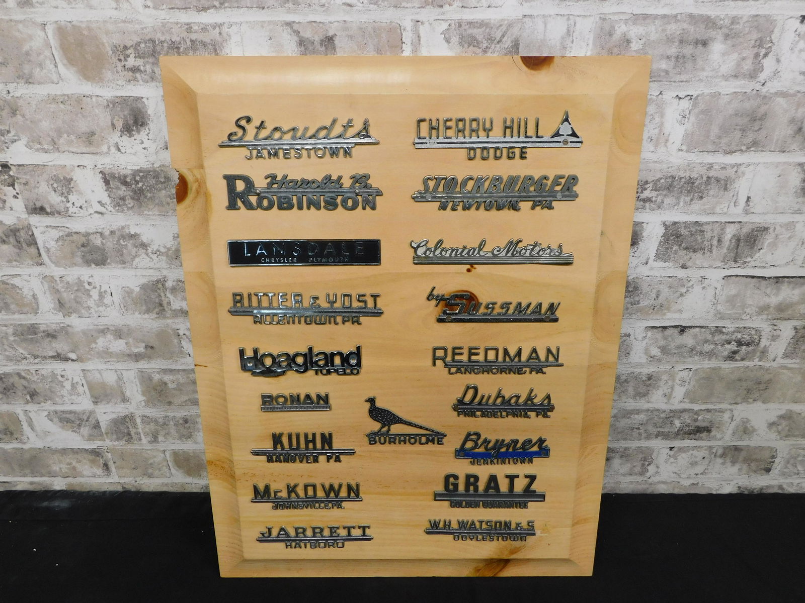 Collage of Car Dealership Name Plates: Collage of Car Dealership Name Plates. Mostly Chrysler and Dodge. Measures approx. 24" tall x 18" wide. Please read the terms and conditions. This sale will be broadcast live on sale day with full des