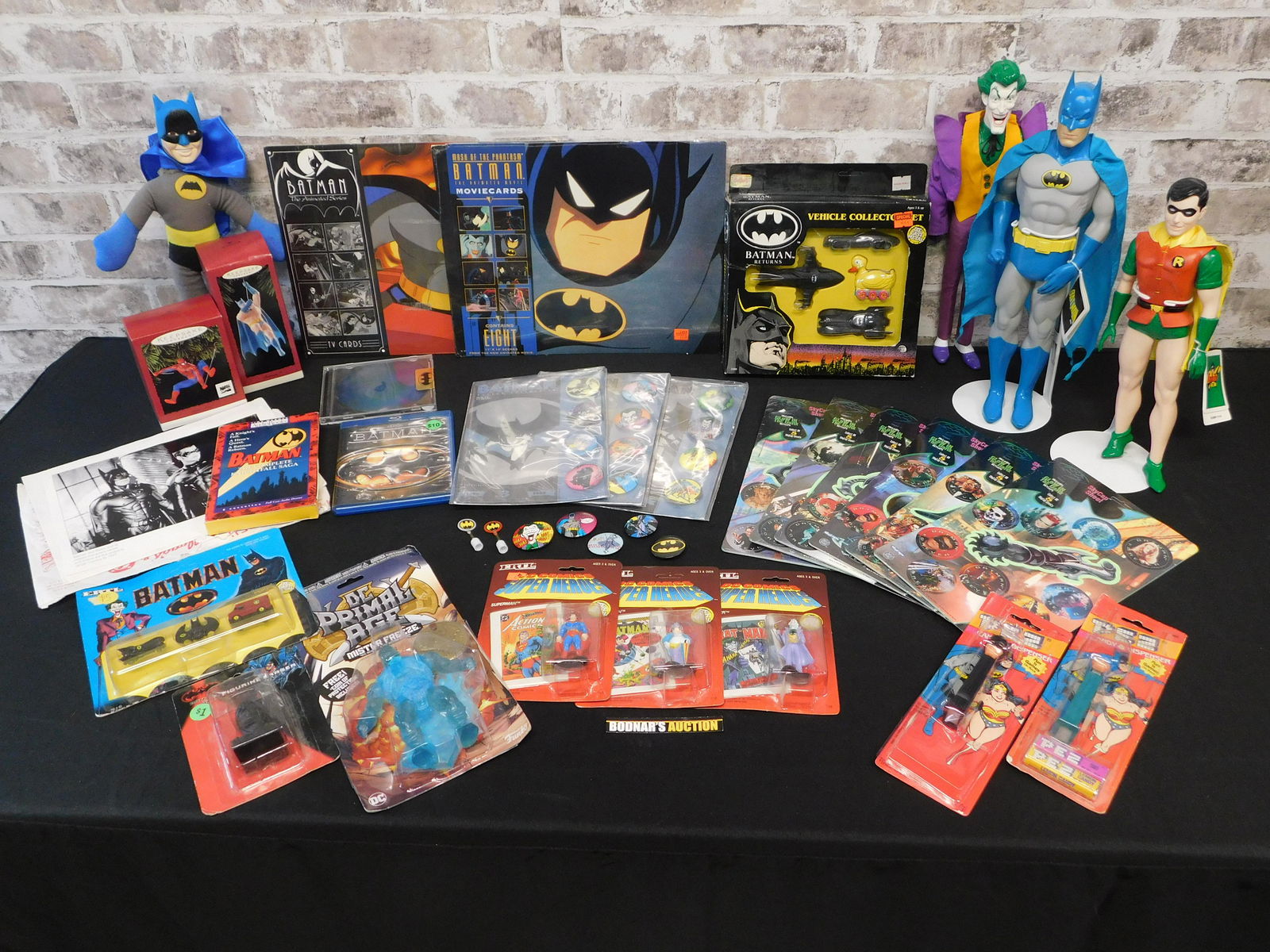 Large Lot of Batman/DC Items: Large Lot of Batman/DC Items including Presents Figures, Pez Dispensers, Buttons, Ornaments, and More. All items are shipped USPS or UPS and will be billed separately. A $10 handling fee is added to t