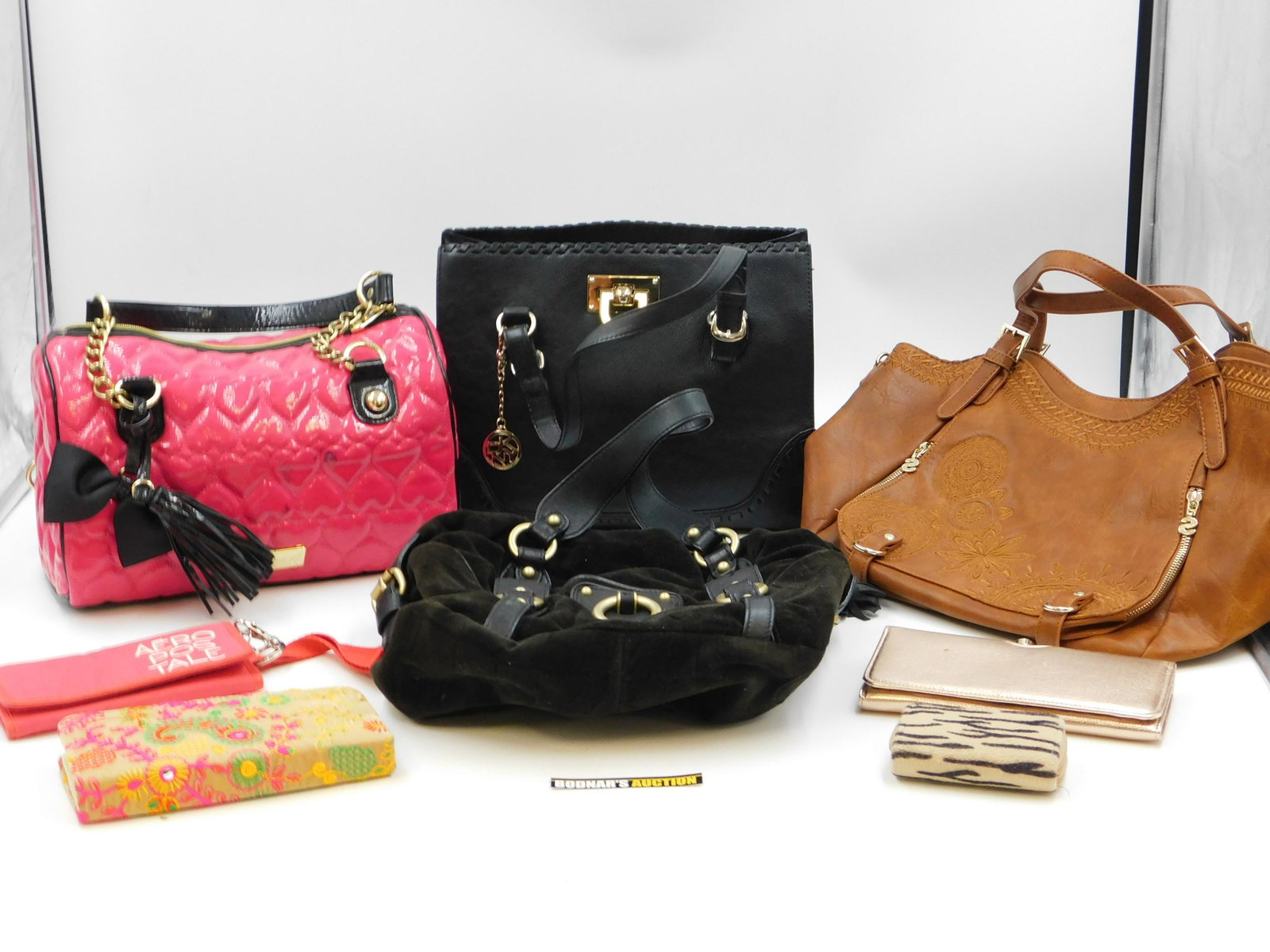 Lot of Handbags, Wallets and Coin Purses: Lot of Handbags, Wallets, Coin Purses and More. Including Juicy, Betsy Johnson, and More. All in Used - Worn Condition. This sale will be broadcast live on sale day with full descriptions of each lot 