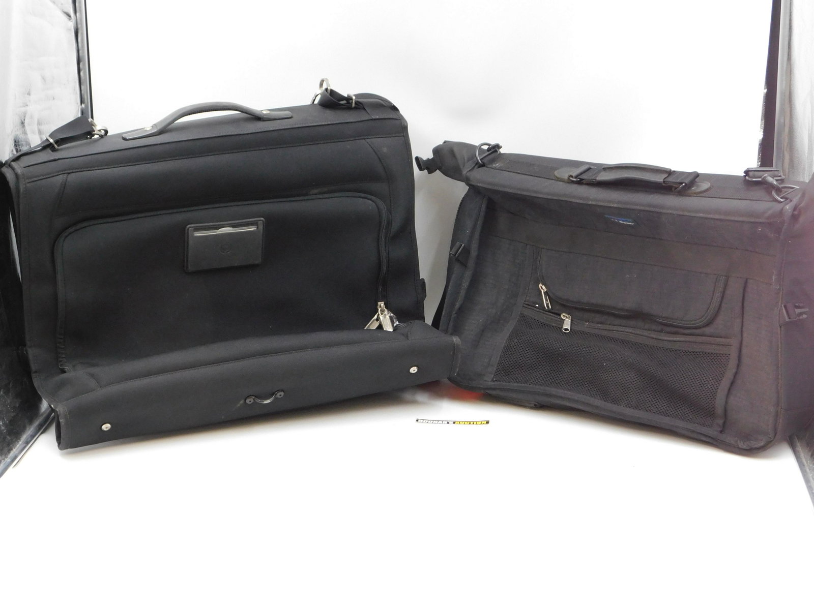 Lot of 2 Garment Bags: Lot of 2 Garment Bags. One is Swiss Army with Plastic. The other is LL Bean in Used Condition. This sale will be broadcast live on sale day with full descriptions of each lot being sold. All items MUS