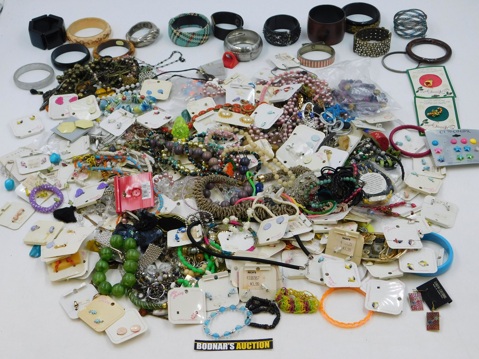 Large Lot of Costume Jewelry: Large Lot of Costume Jewelry. Including Earrings on Cards - Mostly Clip, Rings, Necklaces and More. This sale will be broadcast live on sale day with full descriptions of each lot being sold. All item