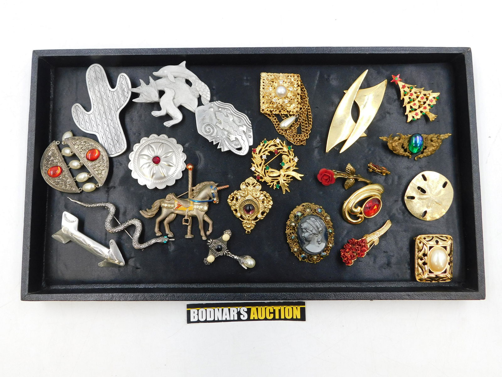Lot of Costume Pins: Lot of Costume Pins including Gold and Silver Tone, Rhinestone, Pearl and More. This sale will be broadcast live on sale day with full descriptions of each lot being sold. All items MUST be paid for w