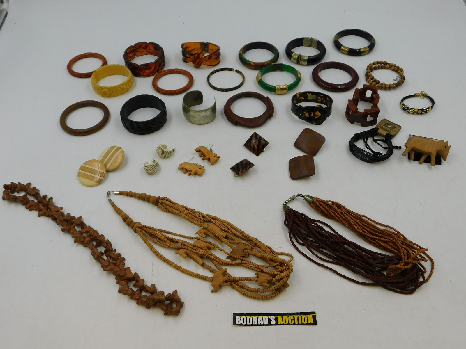 Lot of Costume Jewelry: Lot of Costume Jewelry. Including bangles, Necklaces, and Earrings. Mostly Lucite and Wood. This sale will be broadcast live on sale day with full descriptions of each lot being sold. All items MUST b