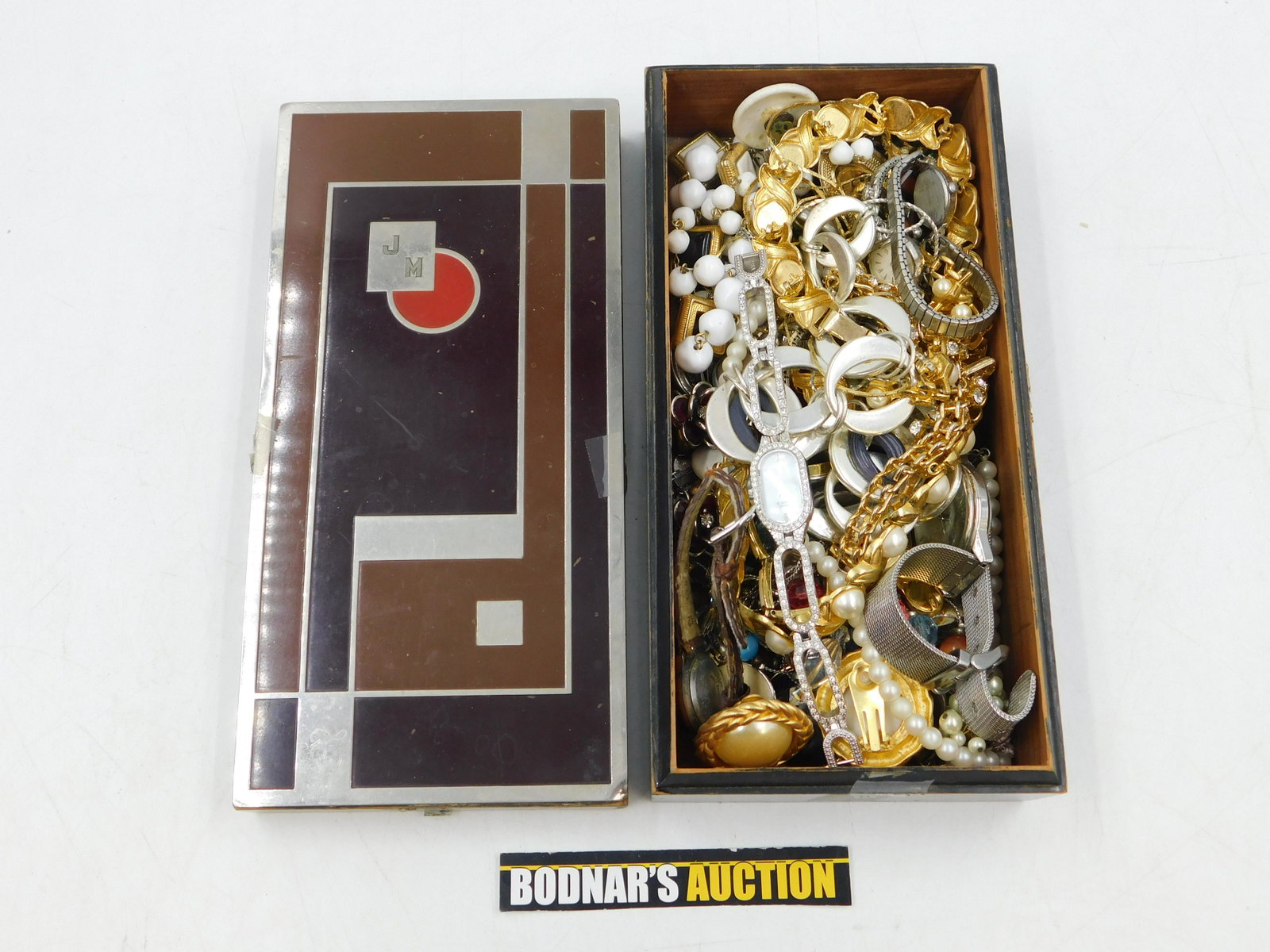 Lot of Costume Jewelry in an Art Deco Inlaid Box: Lot of Costume Jewelry in an Art Deco Inlaid Box. Includes Faux Pearls, Watches, Rhinestones and More. Box has some wear to the sides. This sale will be broadcast live on sale day with full descriptio