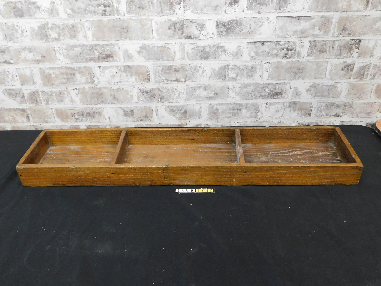 Divided Wooden Tray: Divided Wooden Tray. Appears to be antique. Measures 34" long x 2.5" tall. This sale will be broadcast live on sale day with full descriptions of each lot being sold. All items MUST be paid for within