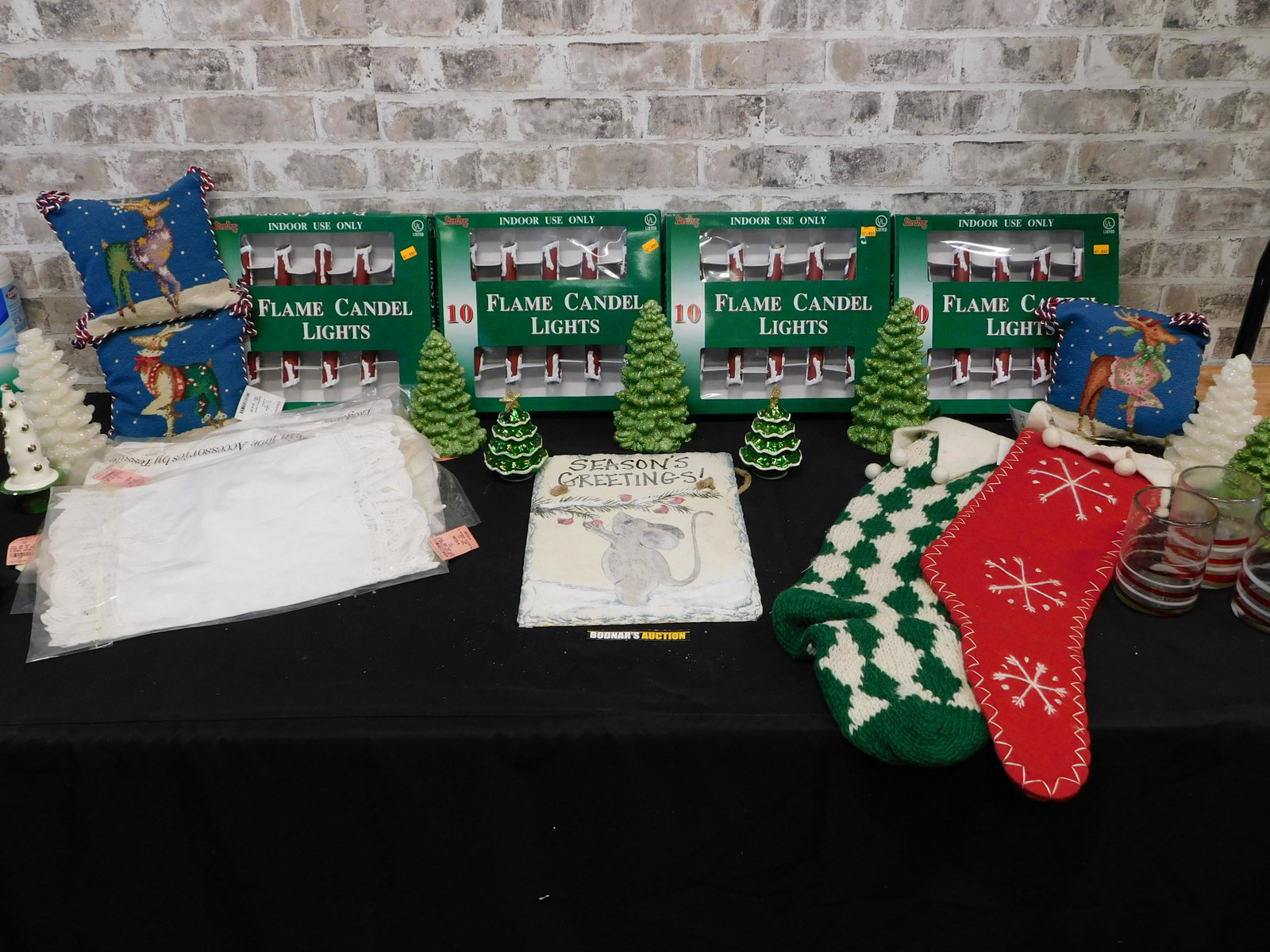 Box Lot of Christmas Items: Box Lot of Christmas Items including Sparkly Christmas Trees, Stockings, Sign, Flame Candle Lights and More. This sale will be broadcast live on sale day with full descriptions of each lot being sold.
