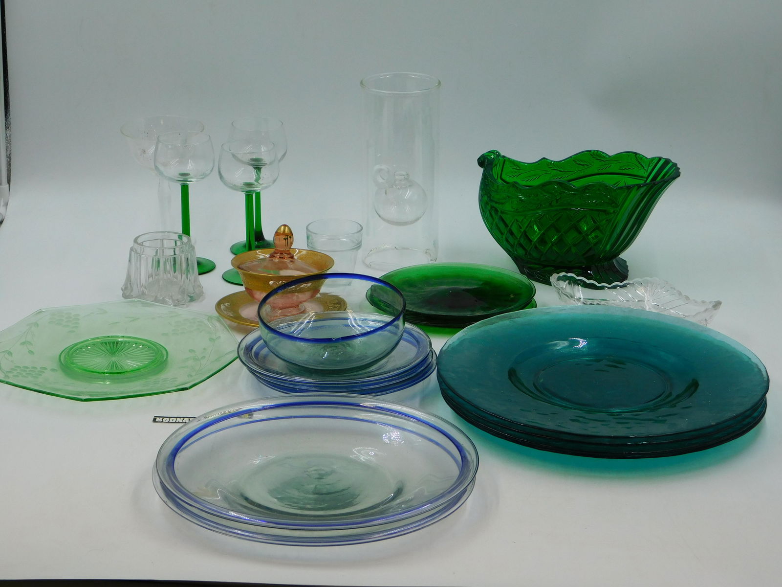 Lot of Glass Dishes and Stems: Lot of Misc. Glassware including Blue Serving Platters, Green Stem Port Wine Glasses, Serving Dishes and More. This sale will be broadcast live on sale day with full descriptions of each lot being sol