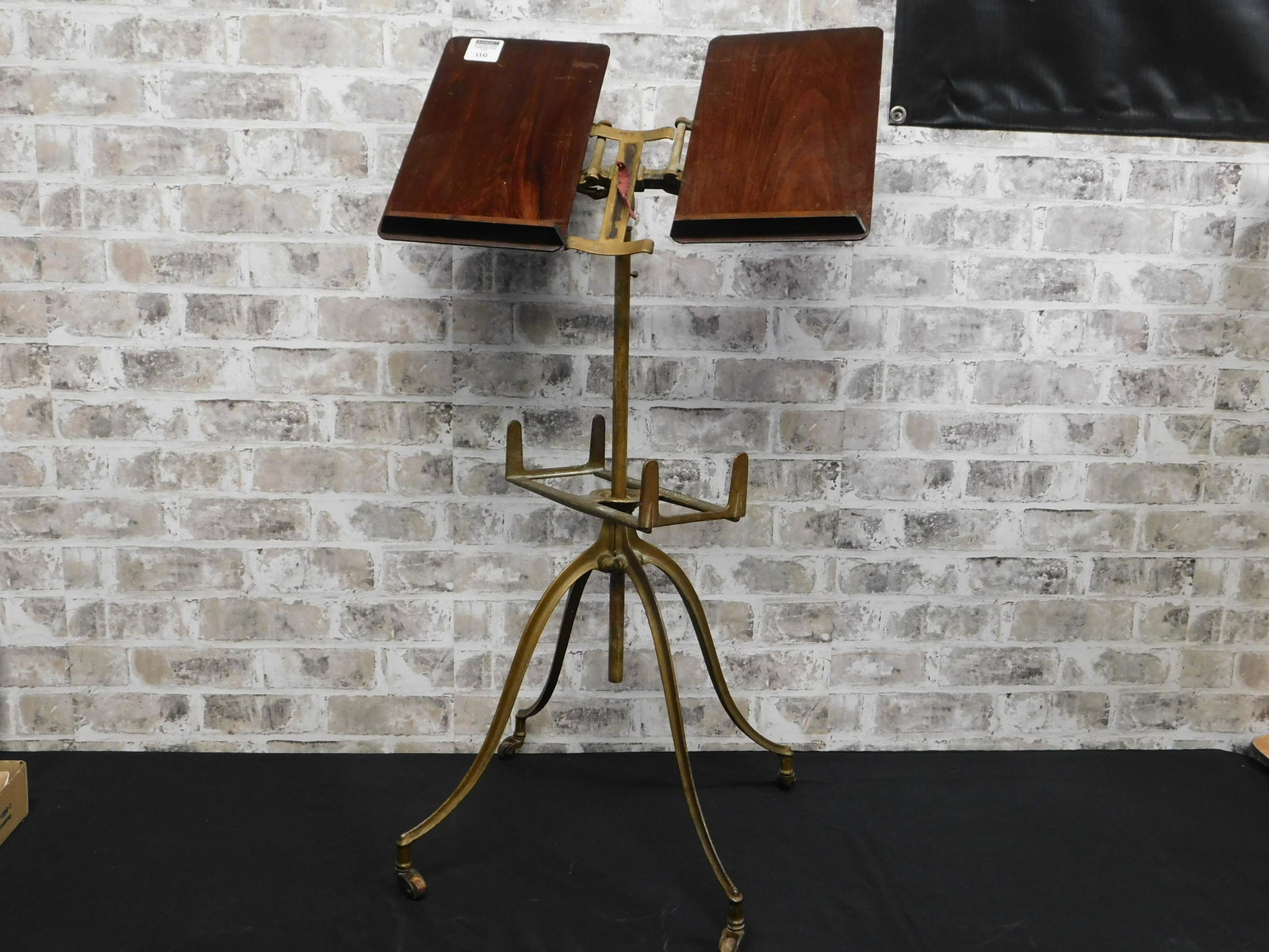 Antique Music Stand: Antique Music Stand with Wooden Top and Metal Rollers on all 4 Feet. Measures 34" tall. Appears to be in good condition. This sale will be broadcast live on sale day with full descriptions of each lot