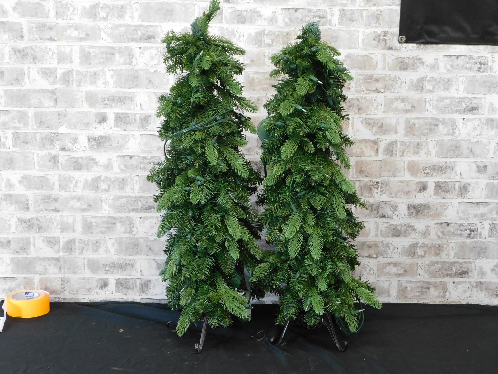 Pair of Pre-Lit Plug In Christmas Trees: Pair of Pre-Lit Plug In Christmas Trees. Measures approx. 38" tall x 11" wide. This sale will be broadcast live on sale day with full descriptions of each lot being sold. All items MUST be paid for wi
