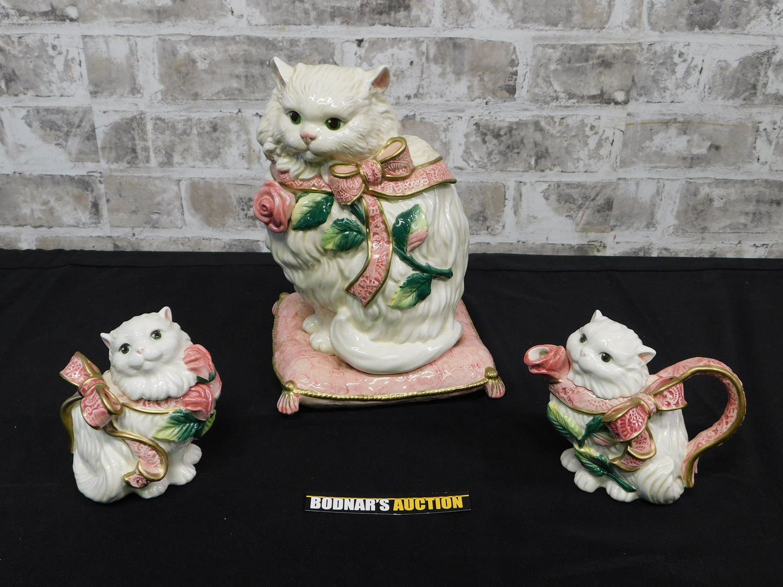 Fitz and Floyd Decorative Cat Cookie Jar Set: 3-Piece Fitz and Floyd Cat and Kitten Creamer, Sugar and Cookie Jar Set. Minor Chip on Bow on the cookie jar. Measures 4"-10" tall x 4"-7" wide. This sale will be broadcast live on sale day with full