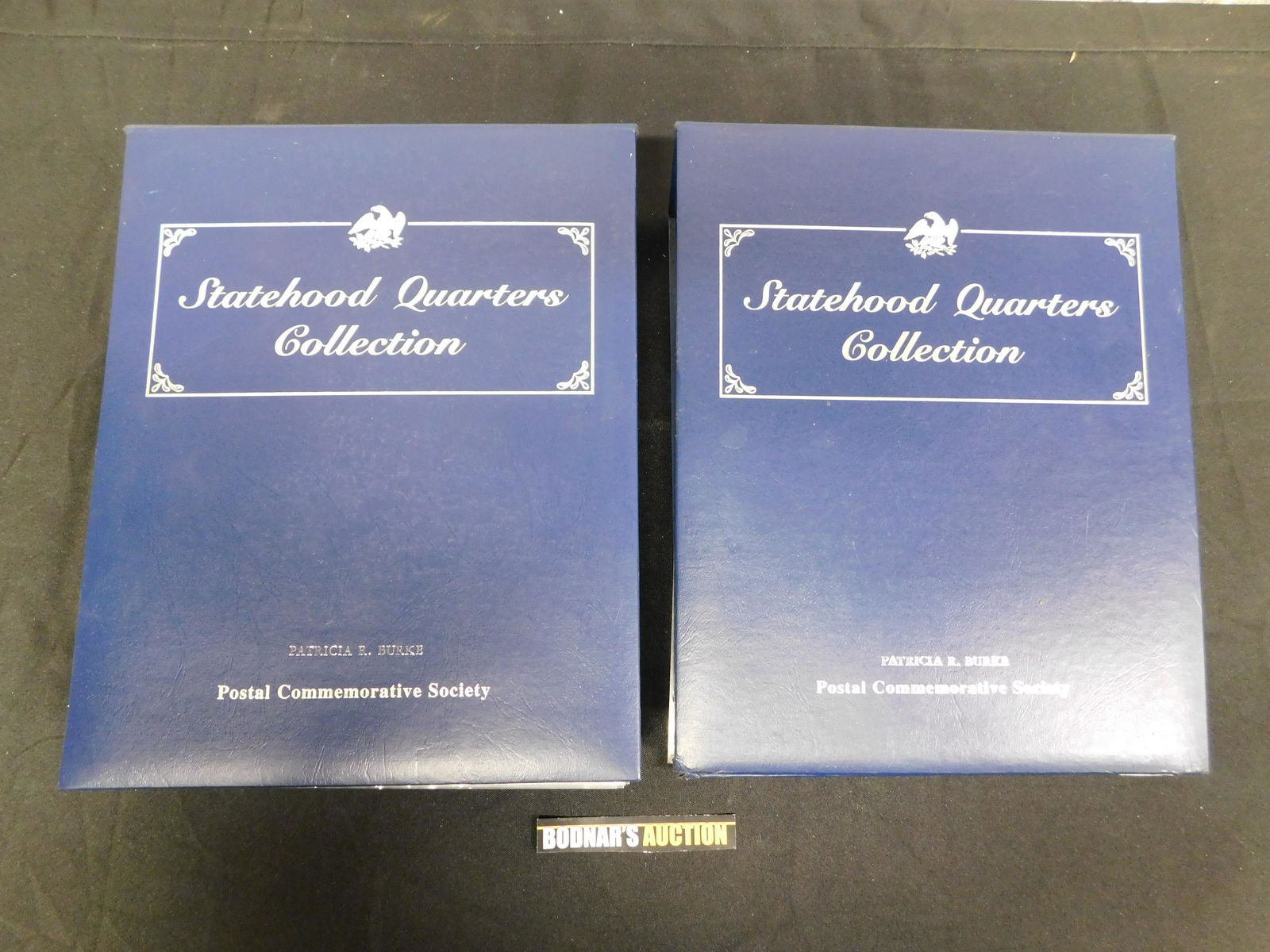 Lot of 2 Postal Commemorative Society Statehood: Lot of 2 Postal Commemorative Society Statehood Quarters Collection Vol 1 and 2 - Complete. This sale will be broadcast live on sale day with full descriptions of each lot being sold. All items MUST b