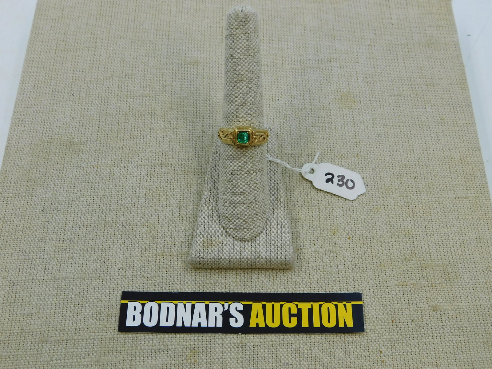 18KT and Emerald Men's Pinky Ring: 18KT and Emerald Men's Pinky Ring. Tested not Marked. Size 8.5. Weighs approx. 5.2 grams. All Gold Weight is approximate. There are no reserves in the entire sale. All invoices must be paid within 24