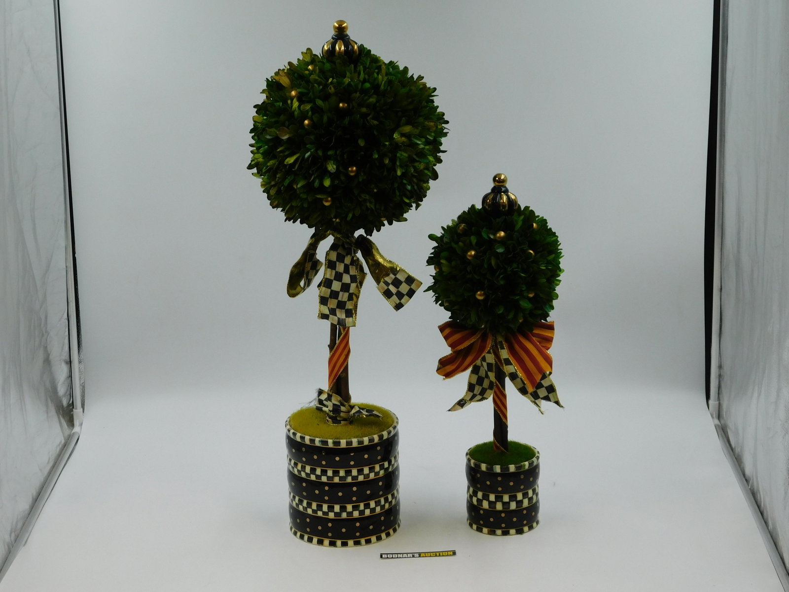 Pair of Mackenzie-Childs Evergreen Accent Trees: Pair of Mackenzie-Childs Evergreen Accent Trees. Heavily Used Condition. Measures approx. 20" and 28" tall x 4" and 7" diameter. There are no reserves in the entire sale. All invoices must be paid wit