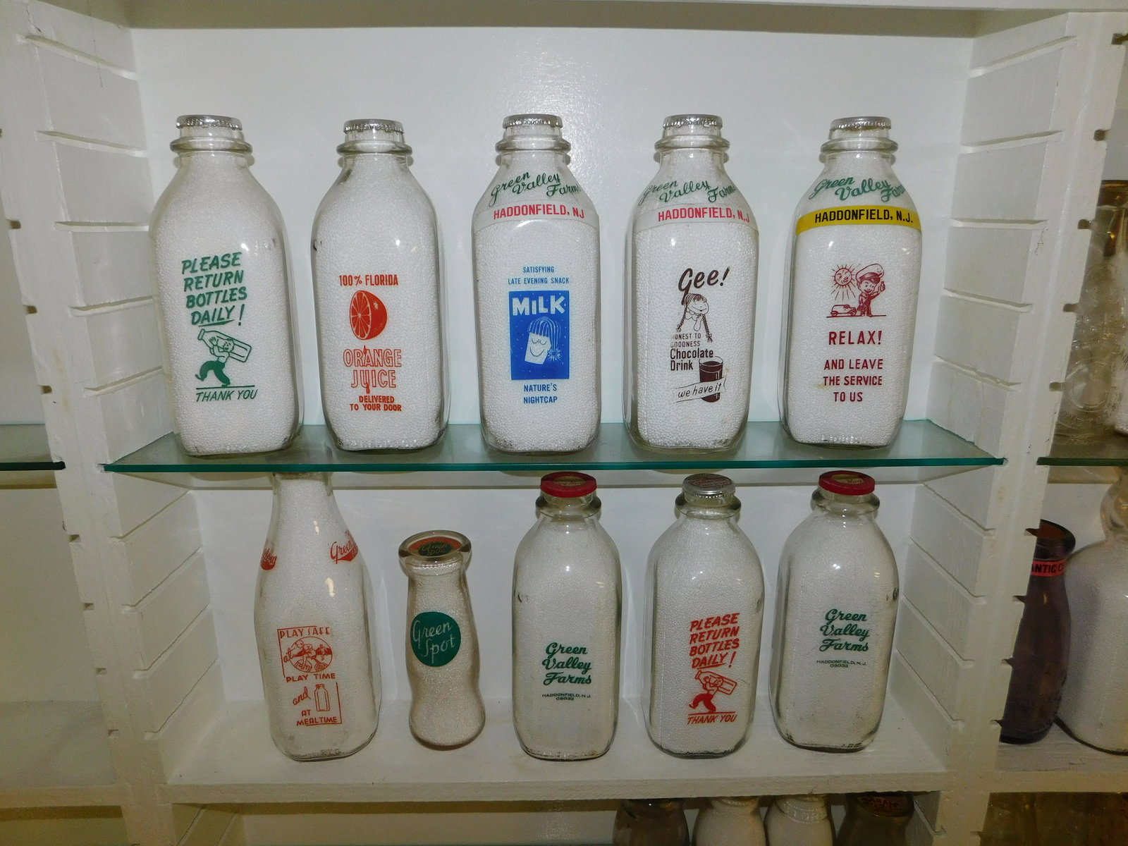 Lot of 10 New Jersey Dairy Bottles: Lot of 10 NJ Dairy Bottles including Green Spot, Green Meadow Farms - Wycoff, and (8) Green Valley Farms - Haddonfield. All bottles have tops. Measures between 7.5" tall and 9.5" tall. Please read the