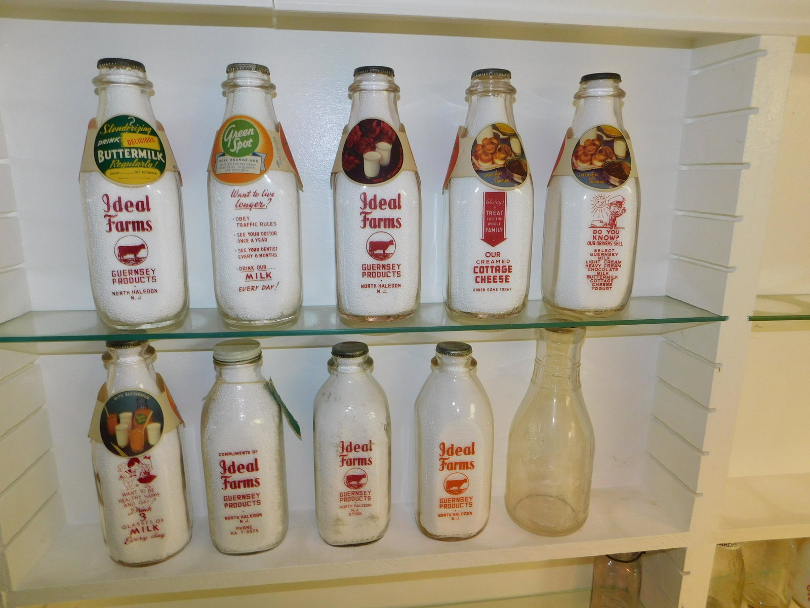 Lot of 10 NJ Dairy Bottles: Lot of 10 NJ Dairy Bottles including 10 Ideal Farms - 9 are from North Haledon and 1 Union. 1 w/paper tag and 6 w/sleeves. All bottles have tops. Measures between 9.5" and 10.5" tall. Please read the 