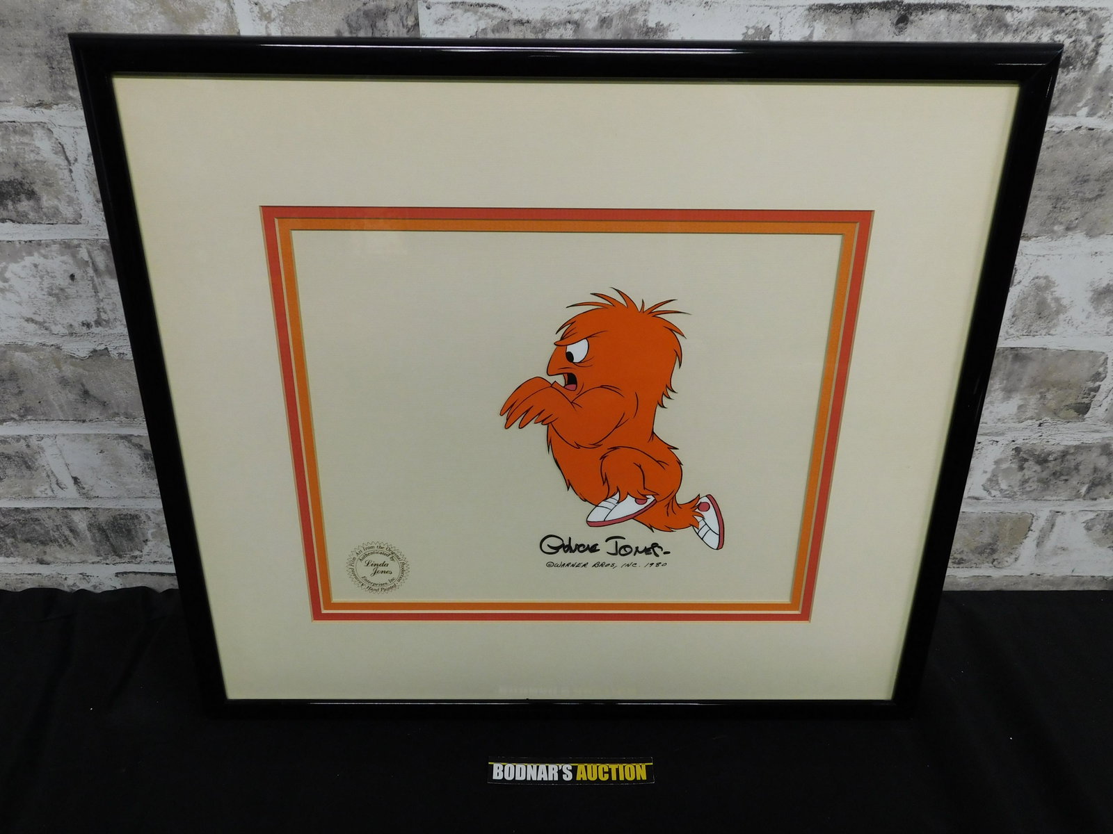 Original Production Cel of Gossamer by Chuck Jones: Original Production Cel of Gossamer by Chuck Jones. Dated 1980. Framed and Matted. Measures 18" wide x 16" tall. Please read the terms and conditions. This sale will be broadcast live on sale day with