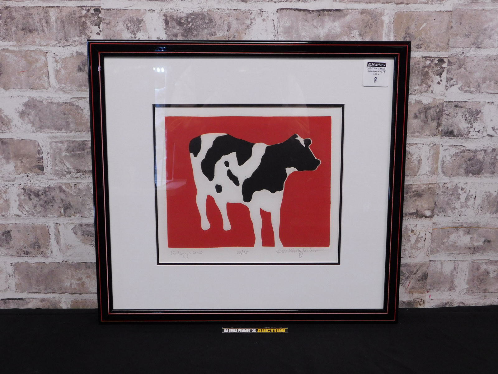 Kelsey's Cow Pencil . Signed Lithograph by Woody Jackson: Signed and numbered framed lithograph by Woody Jackson entitled "Kelsey's Cow". #40 out of 75, pencil Signed lower right. Frame measures approx. 17" tall x 19" wide. Please read the terms and conditio