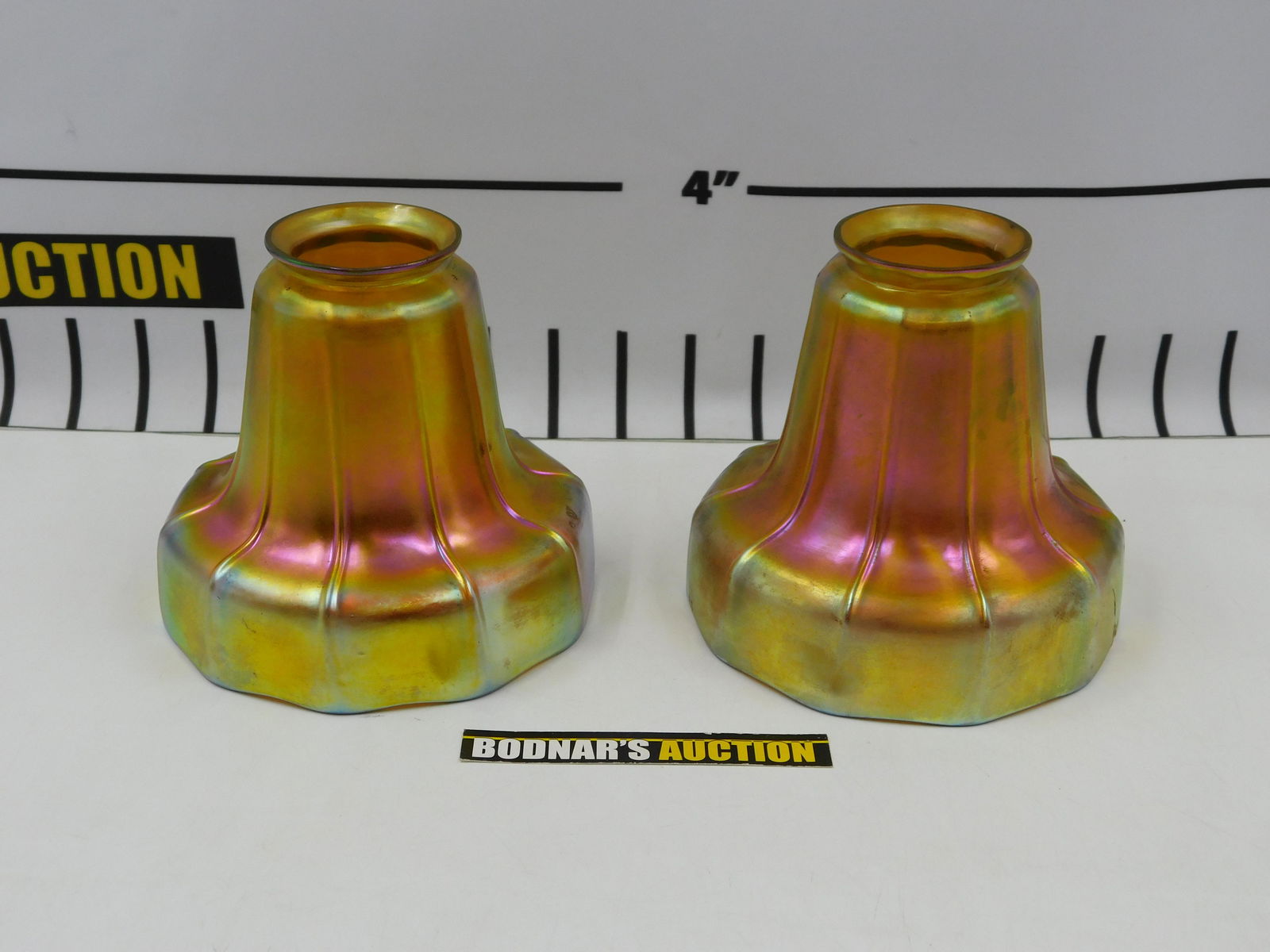 Pair of Art Glass Lamp Shades: Pair of Art Glass Lamp Shades. One has been repaired and is Signed Steuben. Other is unsigned. Measures approx. 5" tall x 5.25" wide. Diameter of fitter is 2.25". All invoices must be paid within 24 h