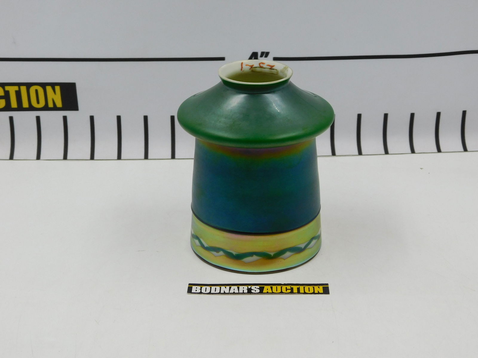 Art Glass Lamp Shade: Art Glass Lamp Shade. Marking in Gold - Appears to be Steuben. Measures approx. 5.5" tall x 4" wide. Diameter of fitter Measures approx. 2". All invoices must be paid within 24 hours of the sale. All