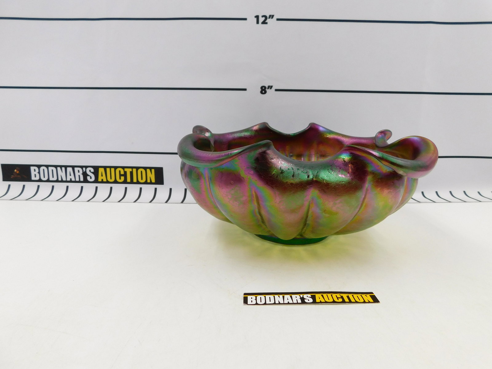 Loetz Art Glass Scalloped Edge Center Bowl: Loetz Art Glass Scalloped edge center bowl Measures approx. 4.75" tall, 11" long. All invoices must be paid within 24 hours of the sale. All items are shipped with Liveauctioneers Live Shipping. Local