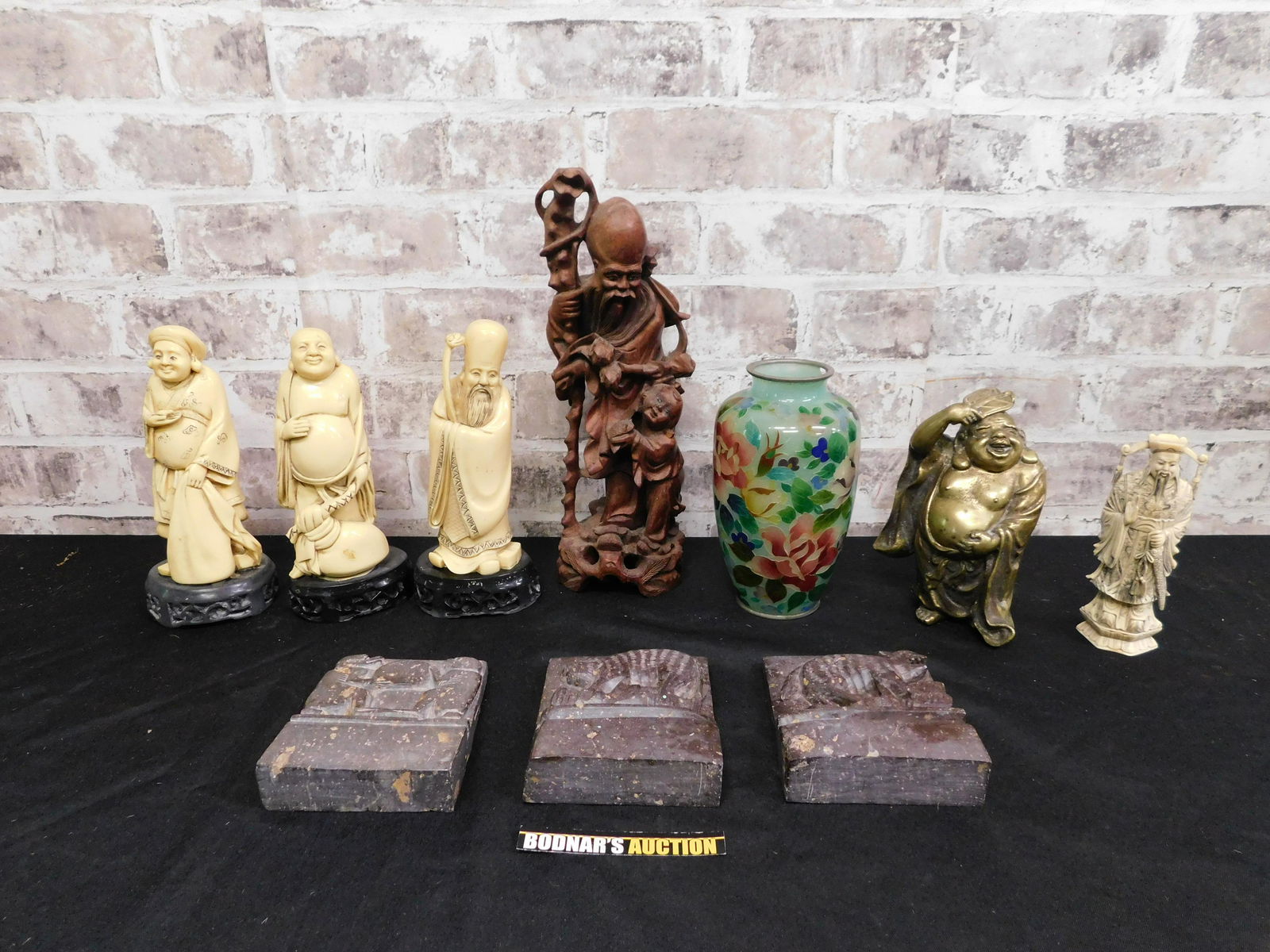 Lot of Asian Decorative Items: Lot of Asian Decorative Items including Wooden Statue, Natural Stone Bookends, Bone Carved Figures, Vase - Chip on Rim, and Brass Buddha. Please read the terms and conditions. This sale will be broadc