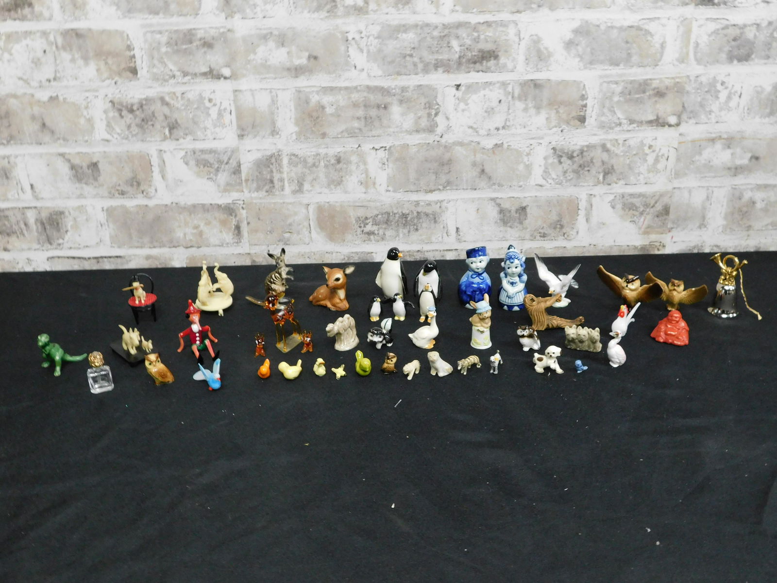 Lot of Miniature Animal and People Figurines: Lot of Miniature Animal and People Figurines. Includes Porcelain, Glass, Wade, Delft, Wooden and More. Some are AS-IS. Please read the terms and conditions. This sale will be broadcast live on sale da