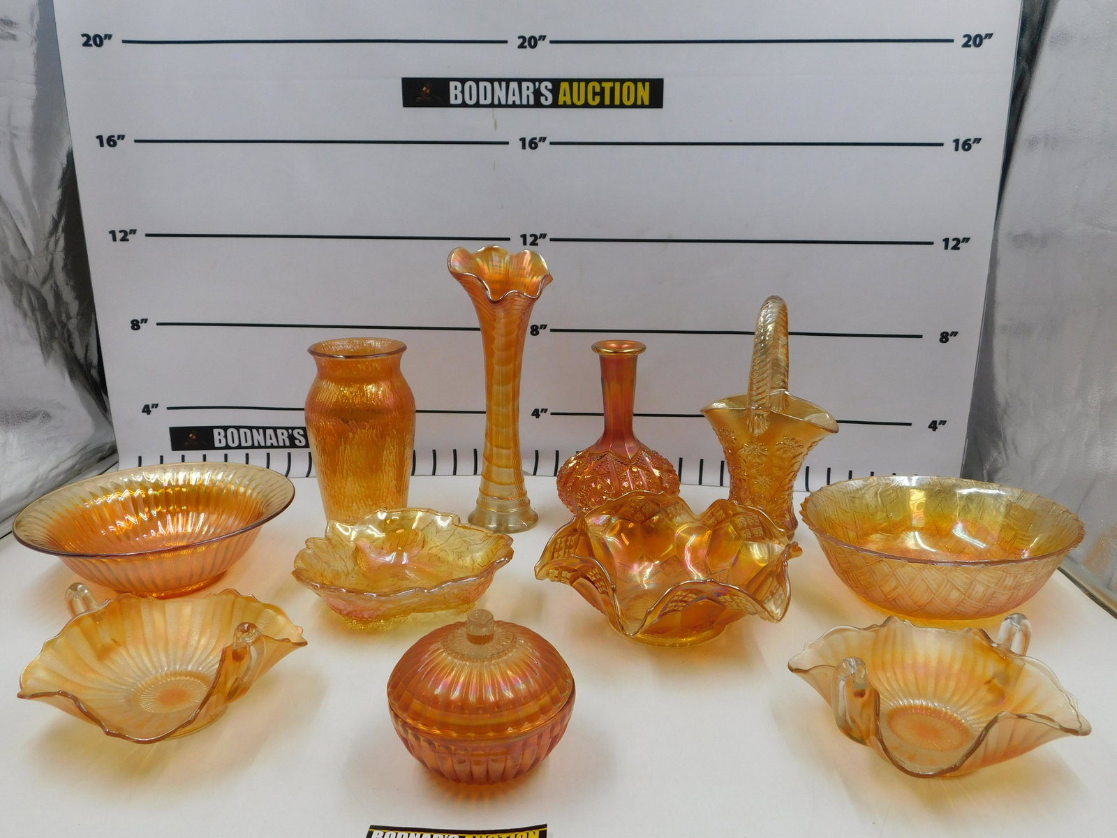 Lot of Carnival Glass: Lot of Carnival Glass. Includes Candy Dishes, Vases, Center Bowls, Basket and More. Please read the terms and conditions. This sale will be broadcast live on sale day with full descriptions of each lo