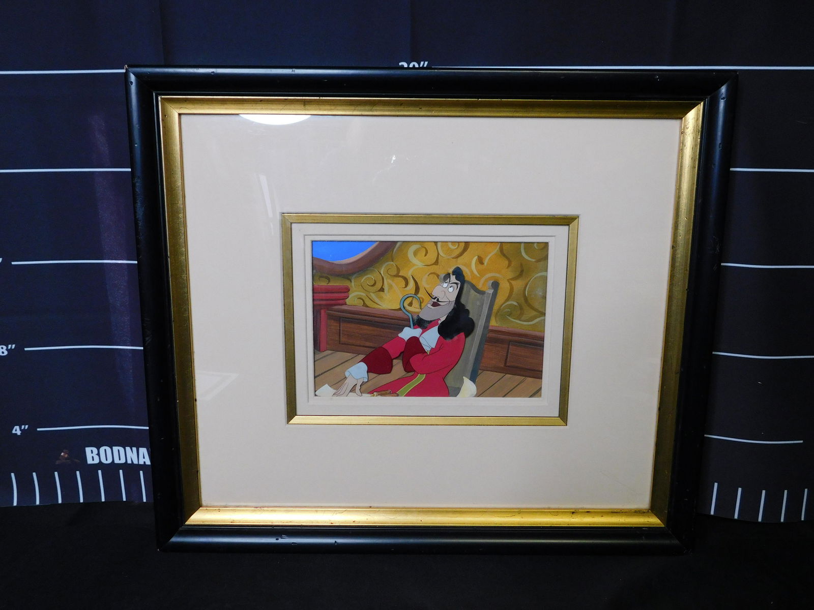 Peter Pan "Captain Hook" Original Production Cel - 1953: Peter Pan "Captain Hook" Original Production Cel on Hand Painted Background - 1953. Framed and Matted. Comes with COA. Cel has some mold by Hook's hair and Frame has heavy damage and mold on the back.