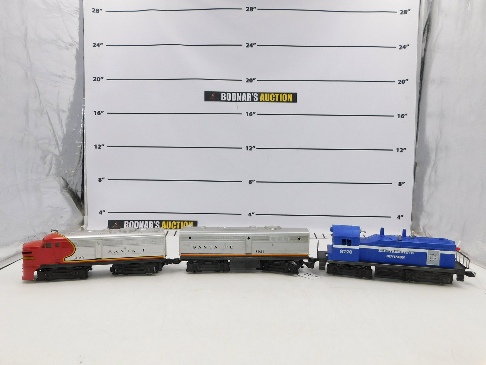 Lot of 3 Lionel Diesel Locomotives: Lot of 3 O Gauge Lionel Diesel Locomotives - EMD #NW2 Switcher 8770, Santa Fe Diesel Locomotive 8020 with Unpowered B Unit 8021. Please read the terms and conditions. This sale will be broadcast live